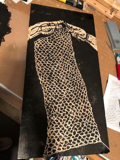 The final inked woodcut before printing.