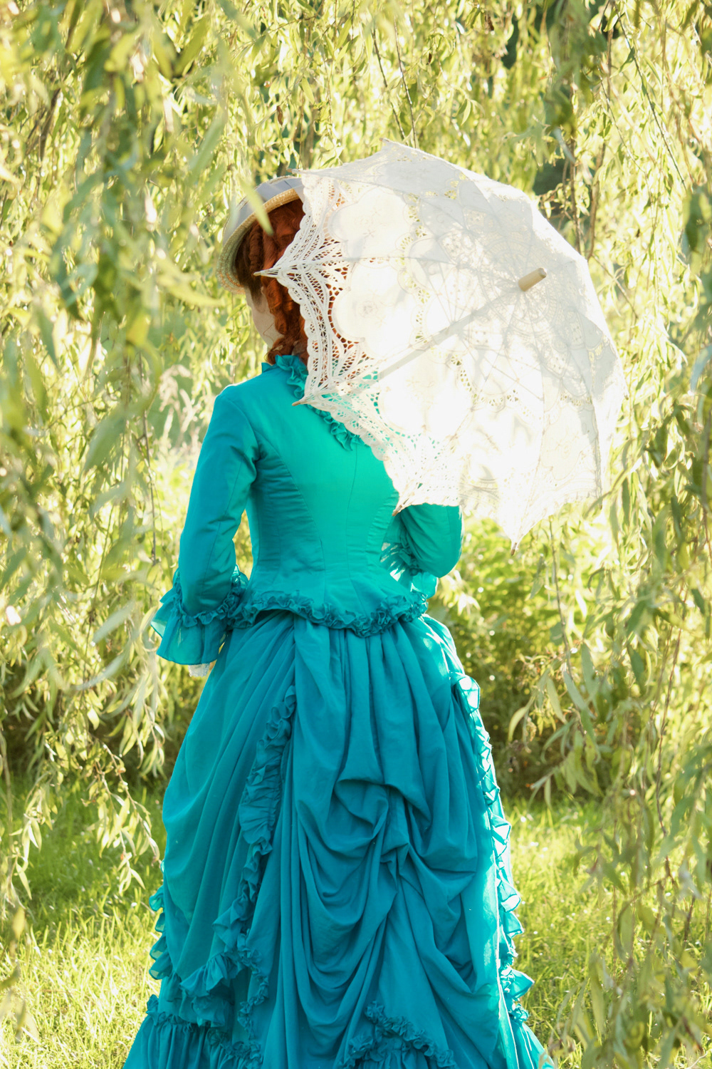 1870s Silk/Cotton Voile Gown: A light summery late Early Bustle period gown with a fitted bodice and gathered flounce detailing. Enquire for Couture pricing.