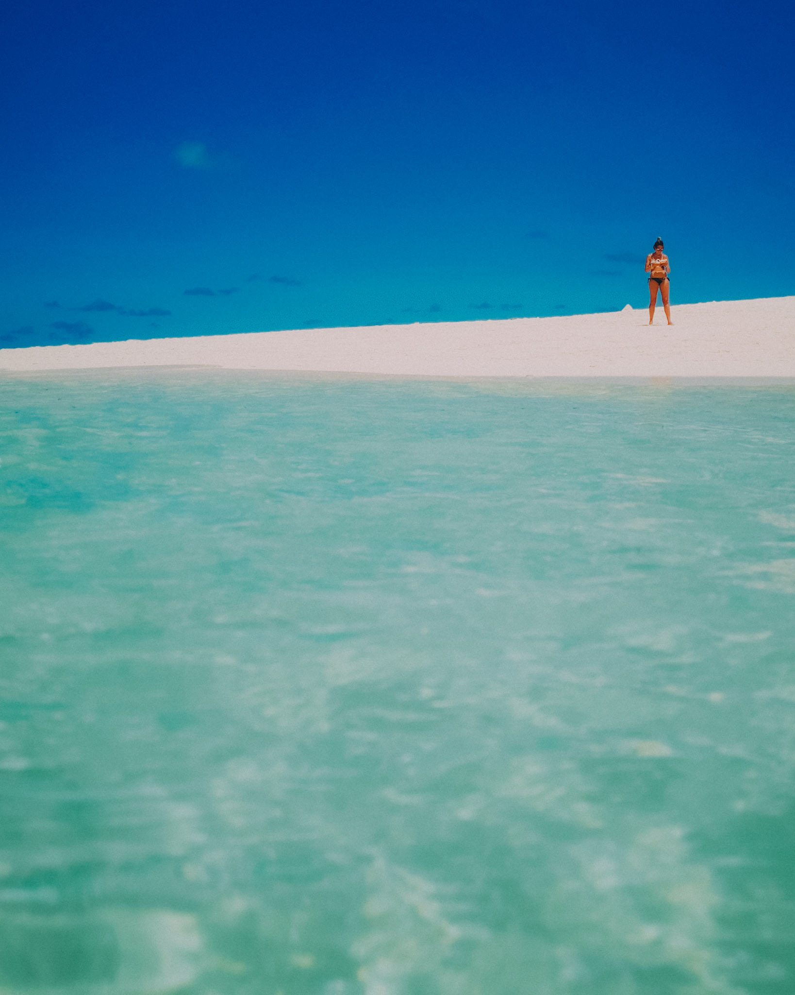 A minimalist photo of an asian girl in a swimsuit, Daku Island, Siargao Island, Philippines, March 2019, Huawei Mate 20 Pro.