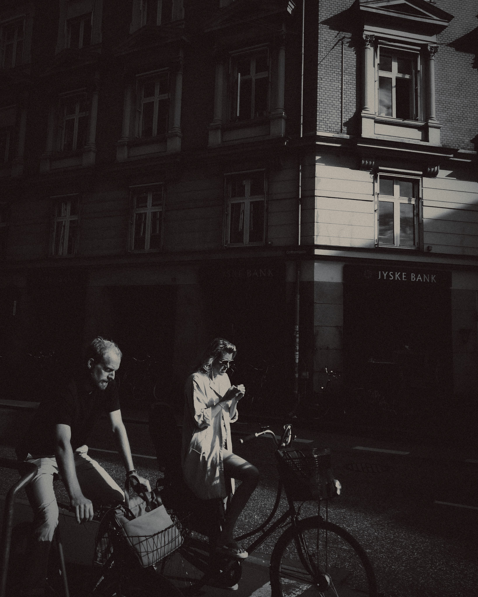 A moody street snapshot of Danes and their city bikes, in black and white, Copenhagen, Denmark, August 2017, Huawei P10 Plus.