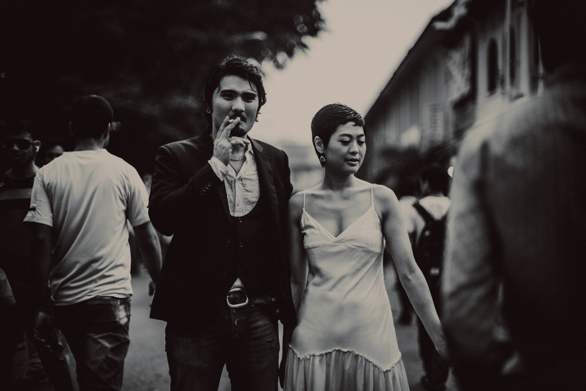 A candid, reportage-style engagement shoot in Little India on a Sunday afternoon feauring a Japanese couple, in black and white, Farrer Park, Singapore, October 2015, Leica M.