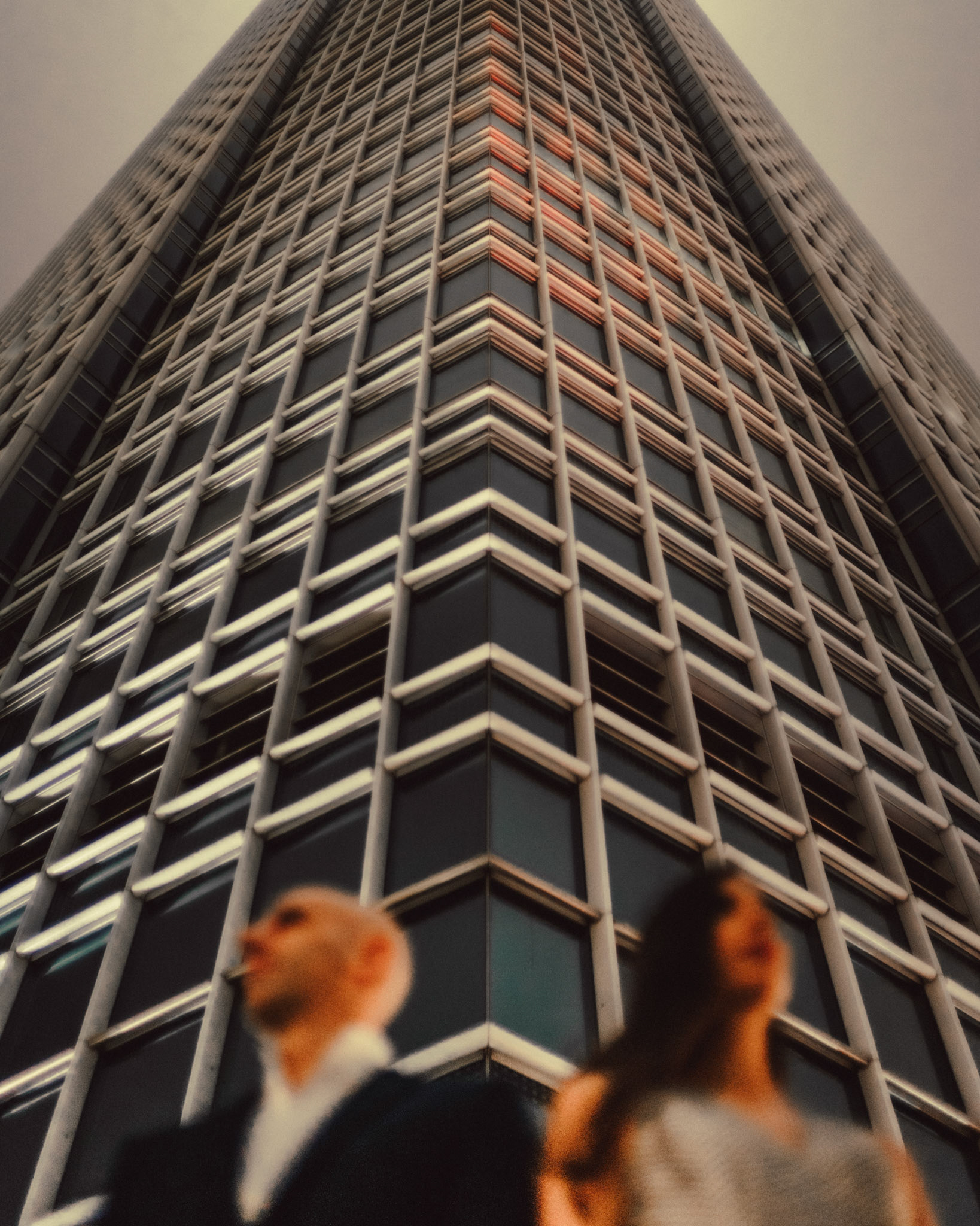 The couple below the Two IFC tower on a foggy night, from Eric and Sabrina's prewedding shoot in Central, Hong Kong, April 2019, Sony A7III.