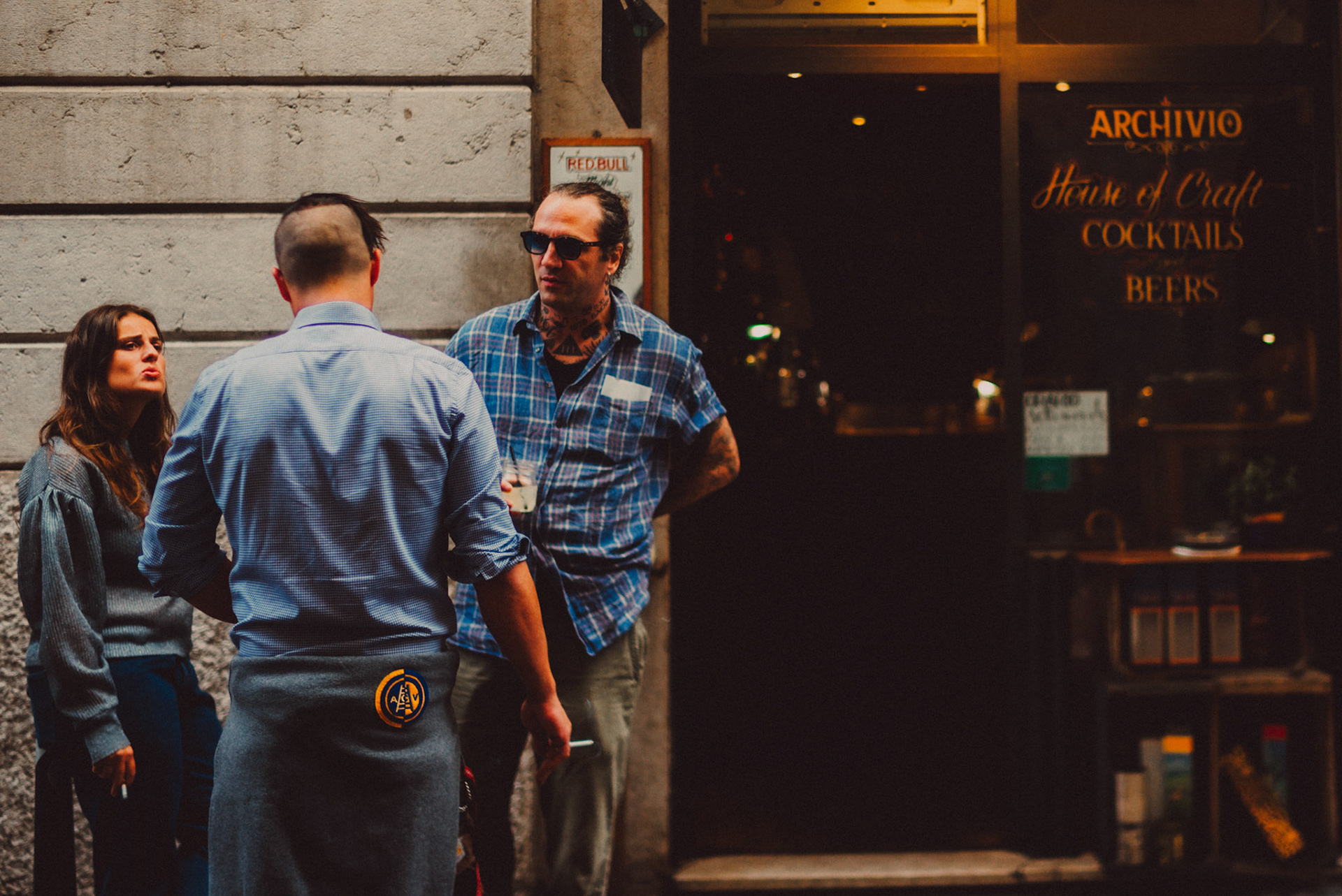 Three people talking while on a cigarette break in front of Archivio, Verona, Italy, September 2017, Leica M.