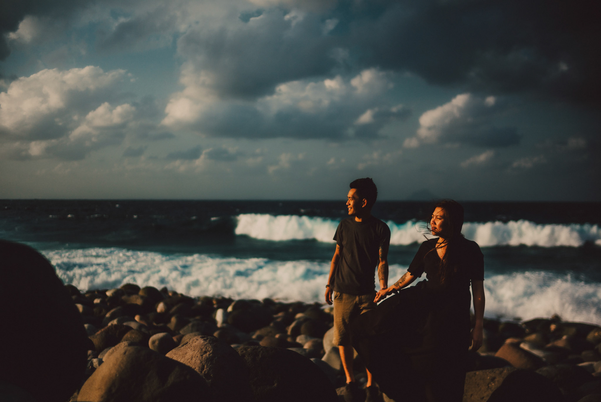 Moody and cinematic couple portraits on a rocky beach, from Owen and Nikka's adventure prenup photoshoot in Chadpidan Boulder Beach, Batanes, Philippines, Southeast Asia, October 2017, Leica M.