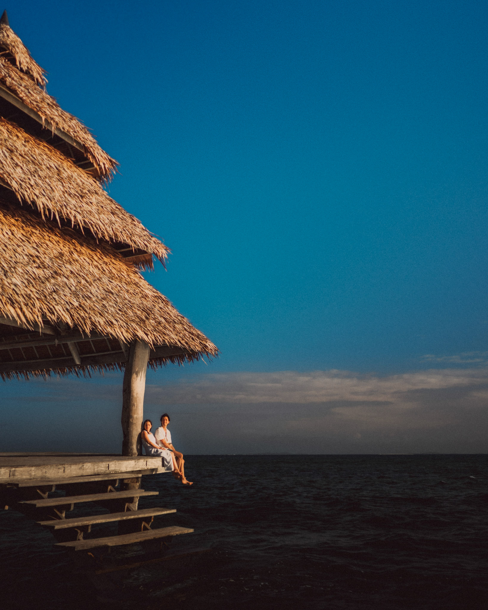 Chill newlywed portraits on Nay Palad Hideaway's floating pagoda in the middle of the sea, from Geo and Bianca's island hopping honeymoon couple portrait shoot in Siargao Island, Philippines, Southeast Asia, February 2020, Sony A7III