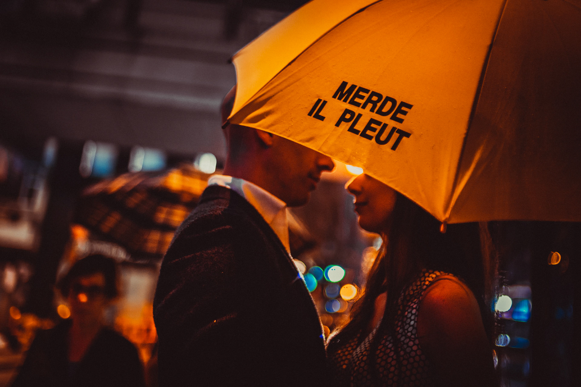 A moody and intimate late night urban engagement shoot with the couple under a bright yellow Merde Il Pleut umbrella, from Eric and Sabrina's prewedding shoot in Central, Hong Kong, April 2019, Sony A7III.