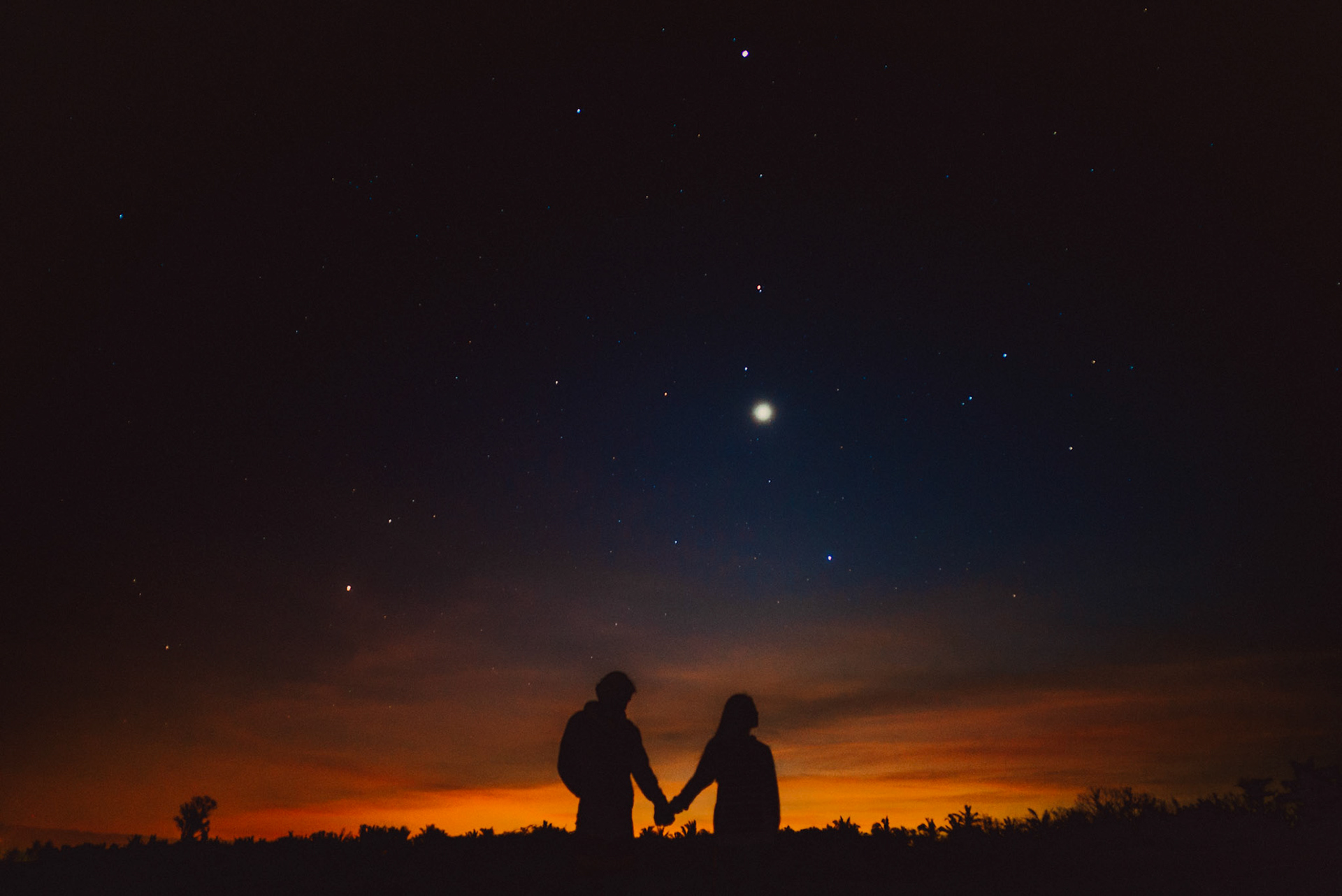 Silhouette couple photos before sunrise with Venus rising visibly above the horizon, Bonuan Beach, Dagupan, Pangasinan, Philippines, Southeast Asia, November 2015, Sony A7S.