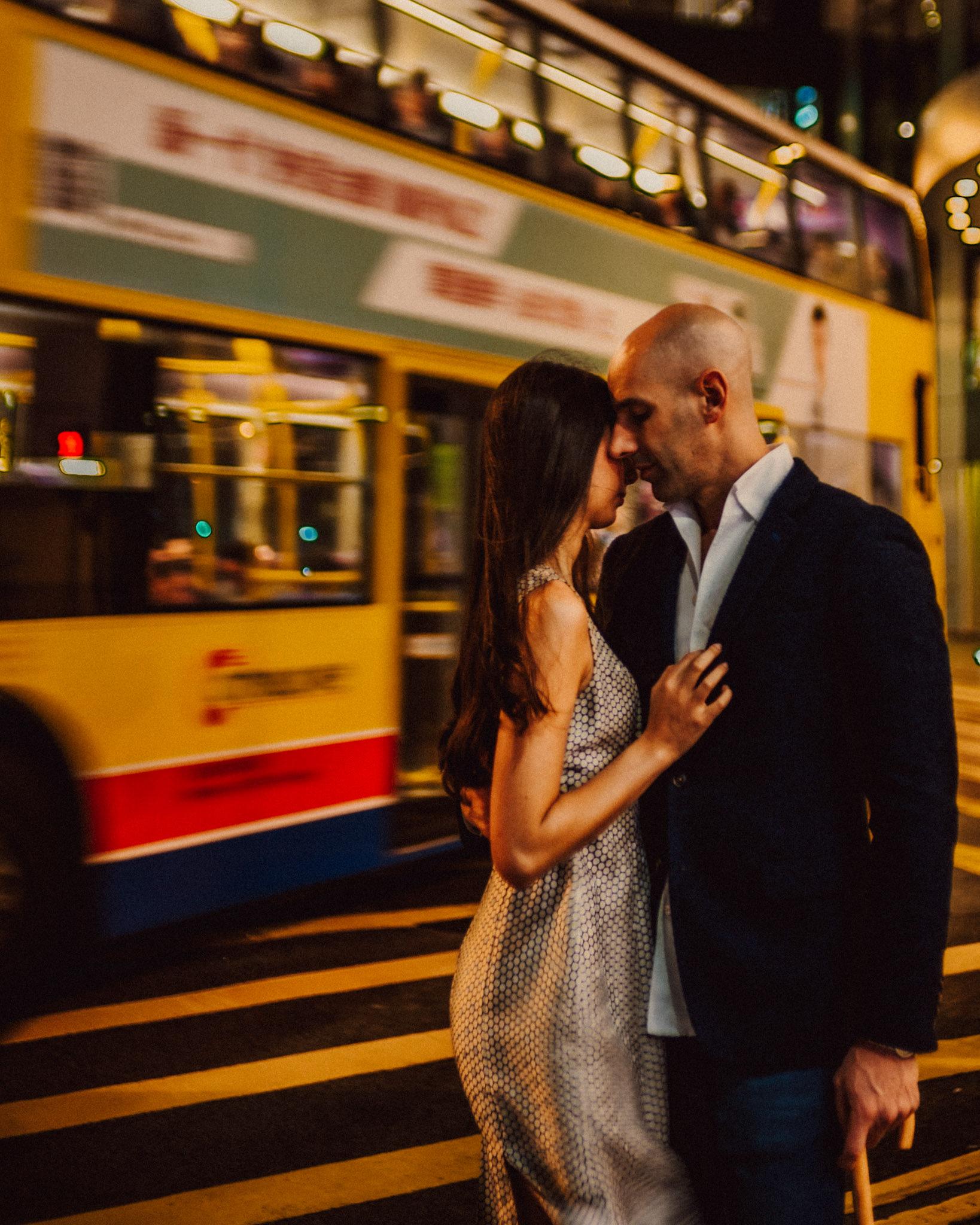 Night city couple portraits in bustling Queen's Road, from Eric and Sabrina's engagement session in Central, Hong Kong, April 2019, Sony A7III.
