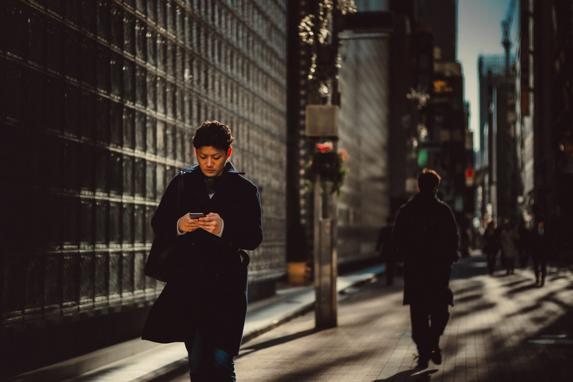 A Japanese man wearing a trench coat in Ginza, Tokyo, Japan, December 2016, Leica M.