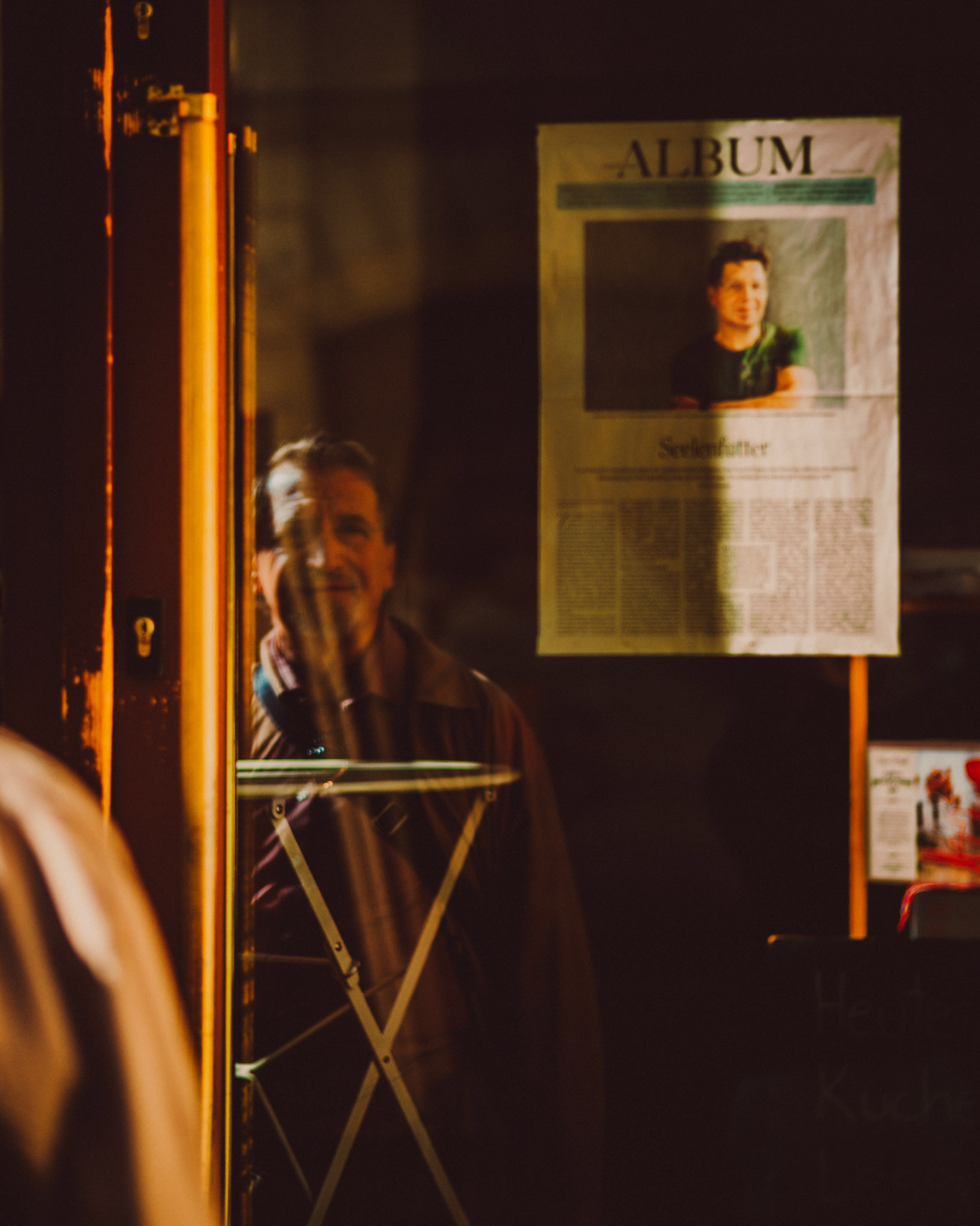 An old man's reflection in a storewindow, Naschmarkt, Vienna, Austria, August 2017, Leica M.