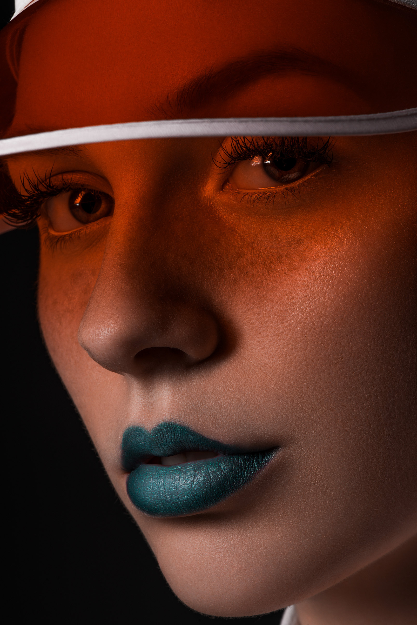 modern photography, model with red transparent cap and blue lipstick