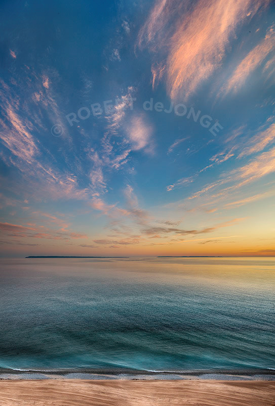 Pre-dawn light fills the sky and waters of the Manitou Passage at Sleeping Bear Point