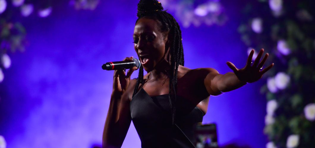 Lindsey ahmet Photography services image example of photography done at the manchester fashion festival an image of Victoria Ekanoye singing on stage