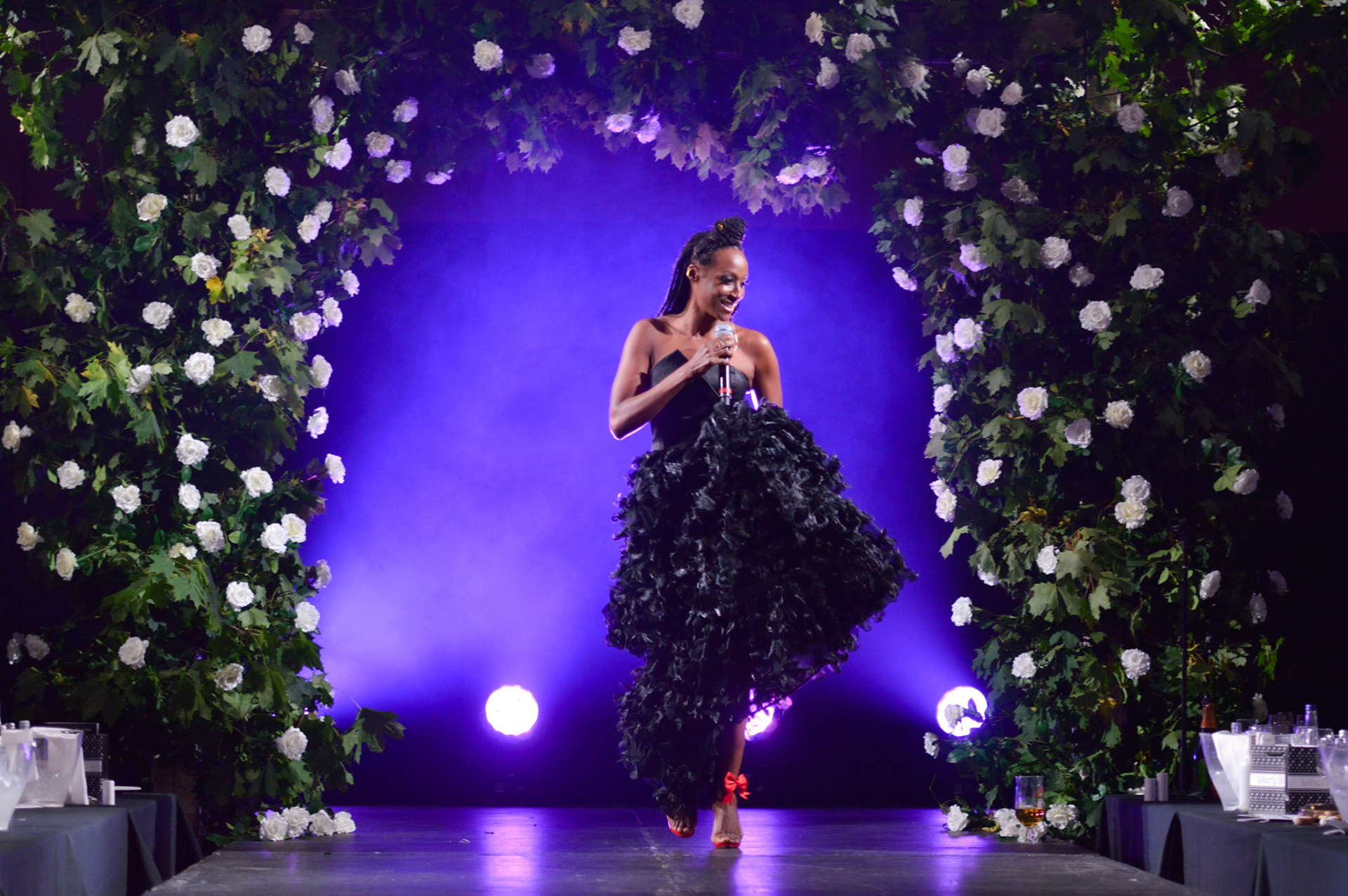 Victoria Ekanoye singing on stage at the 2019 Manchester Fashion Festival - Runway Photographer