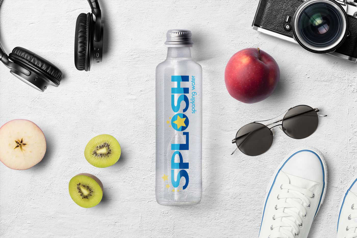 Water bottle showing logo, surrounded by lifestyle elements such as sunglasses and headphones