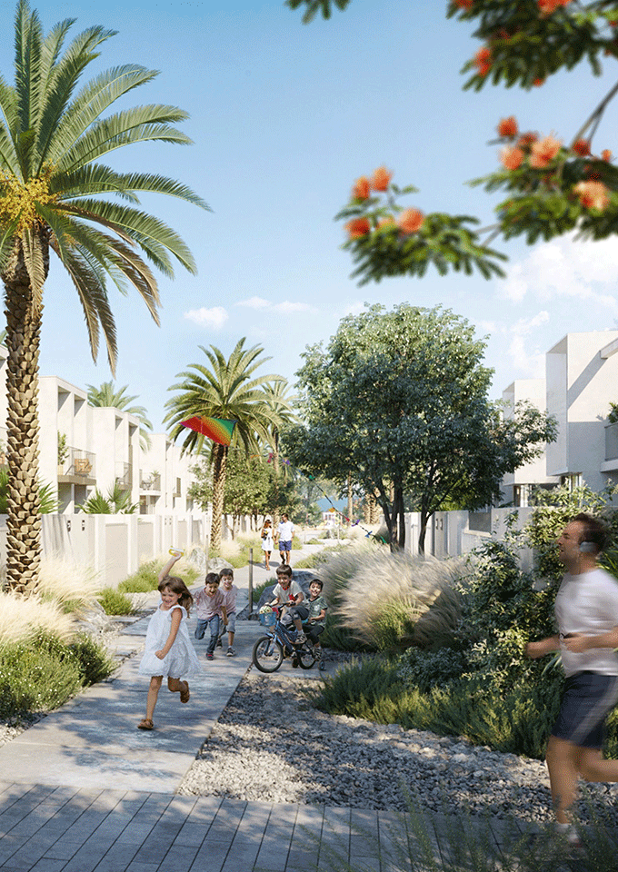Walk able neighborhood design with sikka connections along townhouses. Xeriscaped landscape with rocks and grasses.
