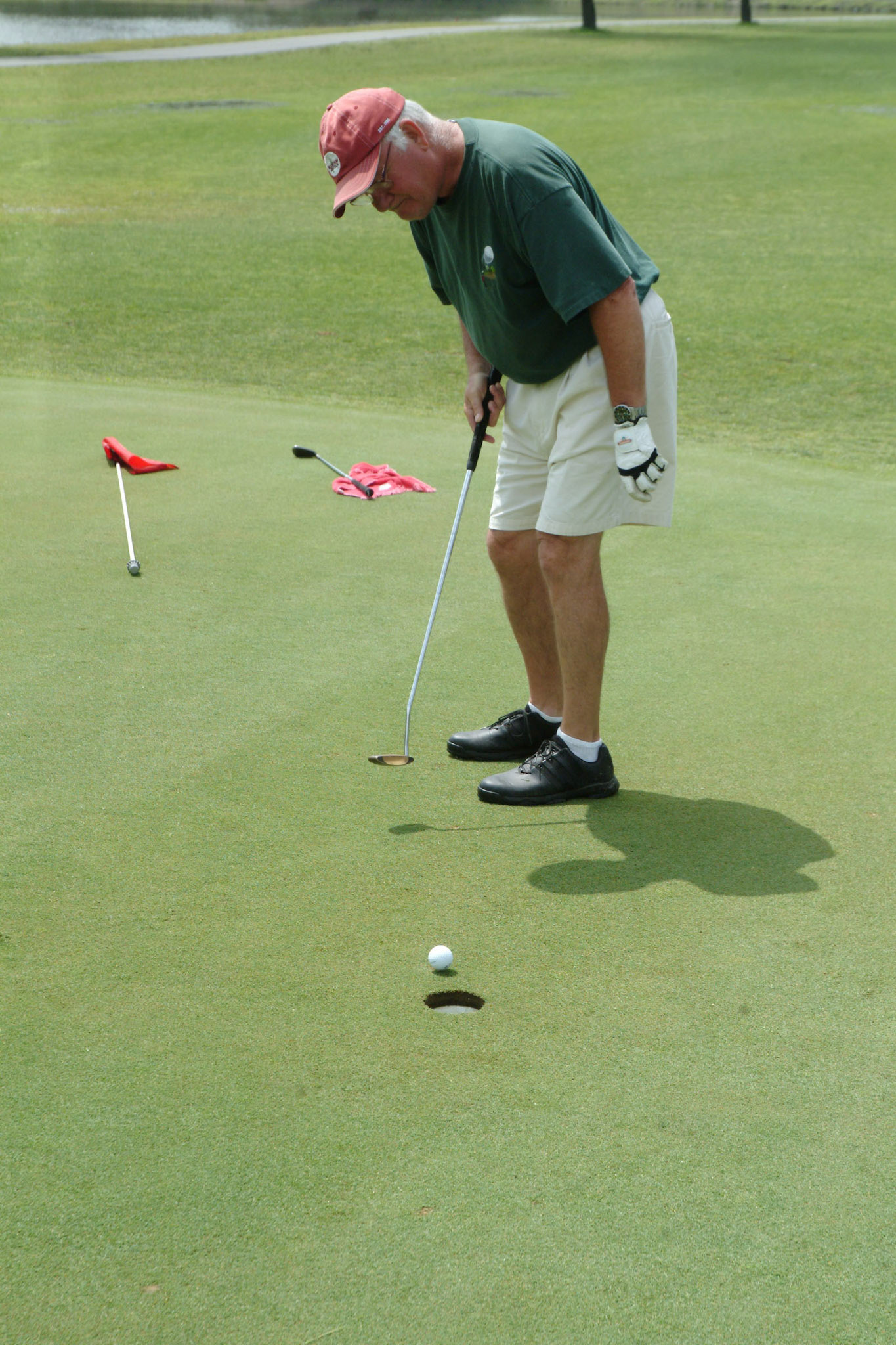 06010tvmGLFWICKER_5 TONY V. MARTIN | THE TIMES HIGHLAND-Russ Marcinek sinks a putt on the rebuilt green of the 10th hole. New course manager John Bierman takes control as upgrades change the face of the Wicker Park Golf Course.
