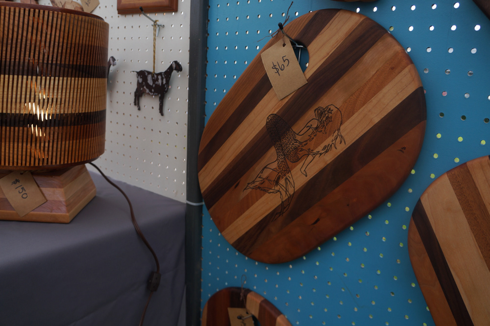 Out of the many pieces they sell, a lone mermaid cutting board hangs on display. It is a leftover piece from the September Mermaid Aqua Faire.
