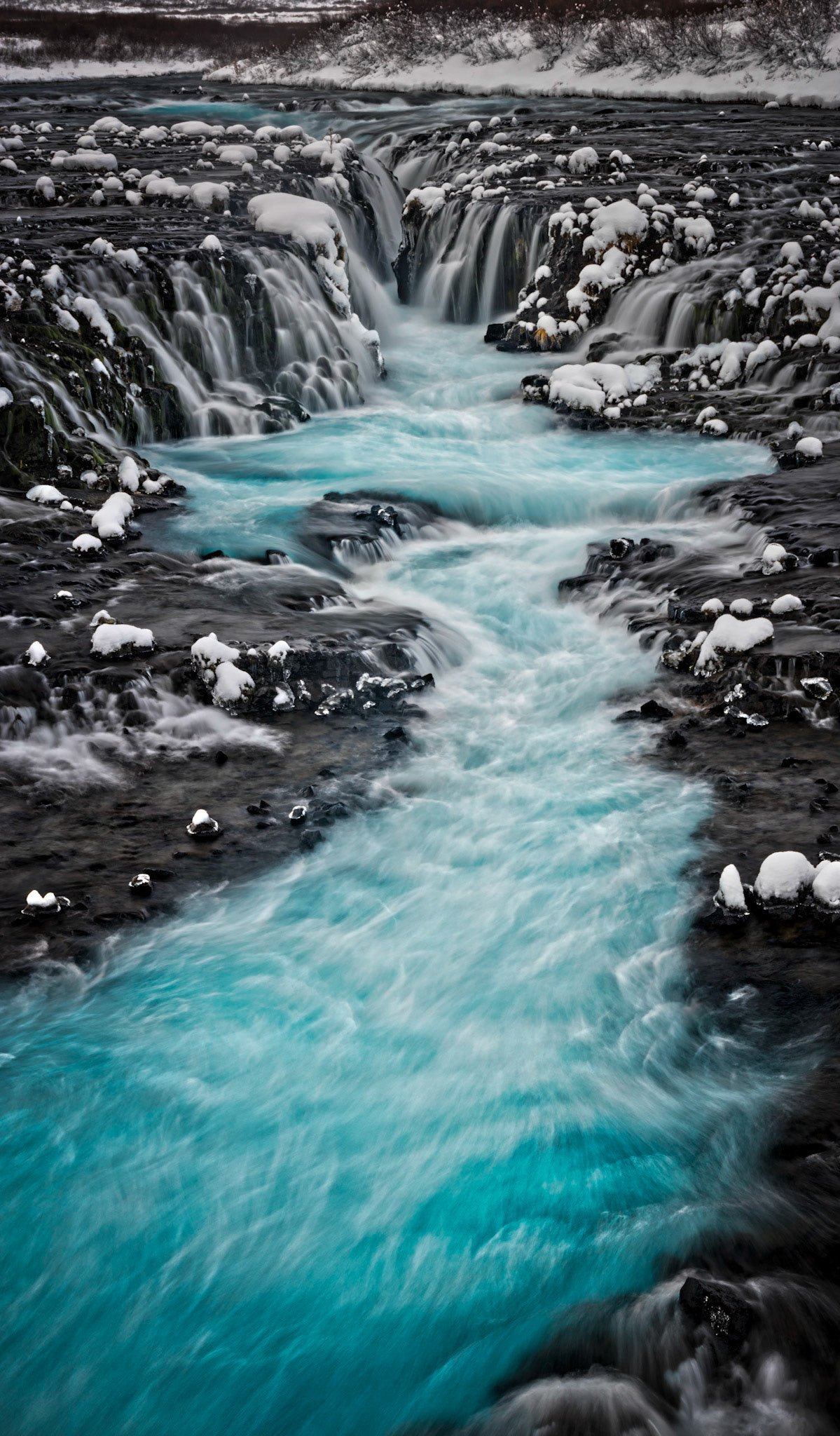 Panoramic image of Brúarfoss, on the Brúará River, near Brekkuskógur, Iceland.South, IcelandJanuary 29, 2016This is an HDR panoramic image consisting of 5 frames comprised of 3 exposures each. HDR processing performed in Photomatix Pro.  Panoramic stitching performed in Photoshop. Additional processing performed in Lightroom and Photoshop.PENTAX K-3, Sigma 18-250mm f/3.5-6.3 DC OS HSMISO 100 63 mm  0.4 sec at ƒ / 11