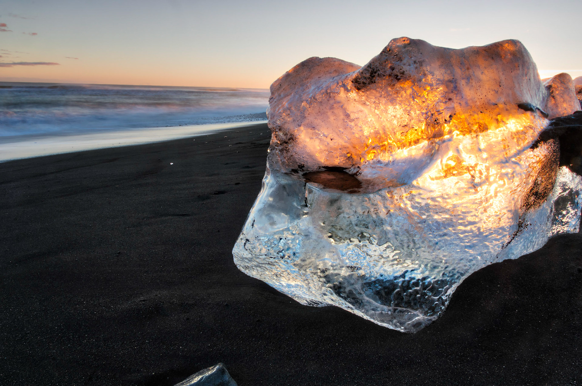 A block of ice catching the rays of the setting sun, along the black sand beach outside of Jökulsárlón.Austurland, IcelandFebruary 9, 2016This is an HDR image consisting of 5 exposures merged in Photomatix Pro. Additional processing in Lightroom and Photoshop.PENTAX K-3, Sigma 18-250mm f/3.5-6.3 DC OS HSMISO 100 18 mm  1.6 sec at ƒ / 20