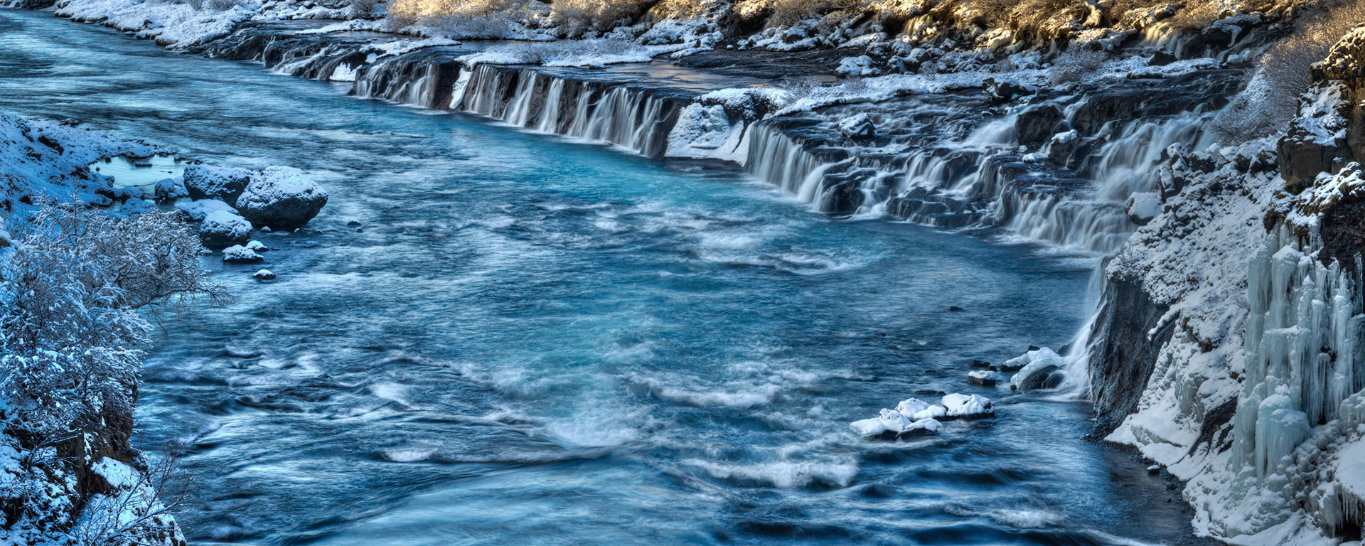 Hraunfossar, where springs of water emerge from under the edge of the Hallmundarhraun lava field, and flow into the Hvítá River.Vesturland, IcelandFebruary 5, 2016This is an HDR panoramic image consisting of 6 frames comprised of 5 exposures each. HDR processing performed in Photomatix Pro.  Panoramic stitching performed in Photoshop. Additional processing performed in Lightroom and Photoshop.PENTAX K-3, Sigma 18-250mm f/3.5-6.3 DC OS HSMISO 100 120 mm  ⅛ sec at ƒ / 18