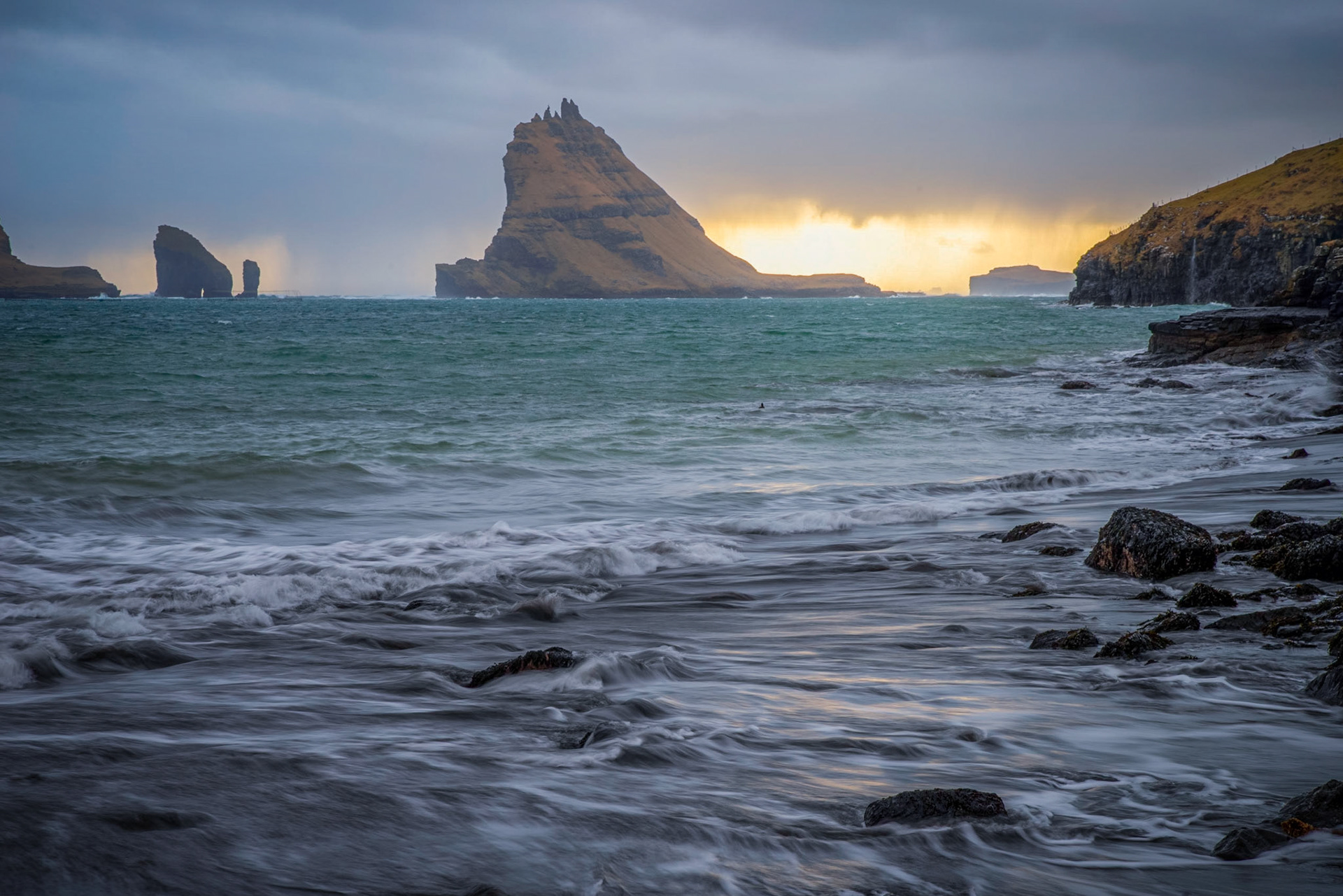 Sunset behind Tindhólmur, near the village of Bøur.Vágar, Faroe IslandsMarch 23, 2019Pentax K-1, HD PENTAX-D FA 24-70mm F2.8ED SDM WRISO 100 65 mm  ⅛ sec at ƒ / 16