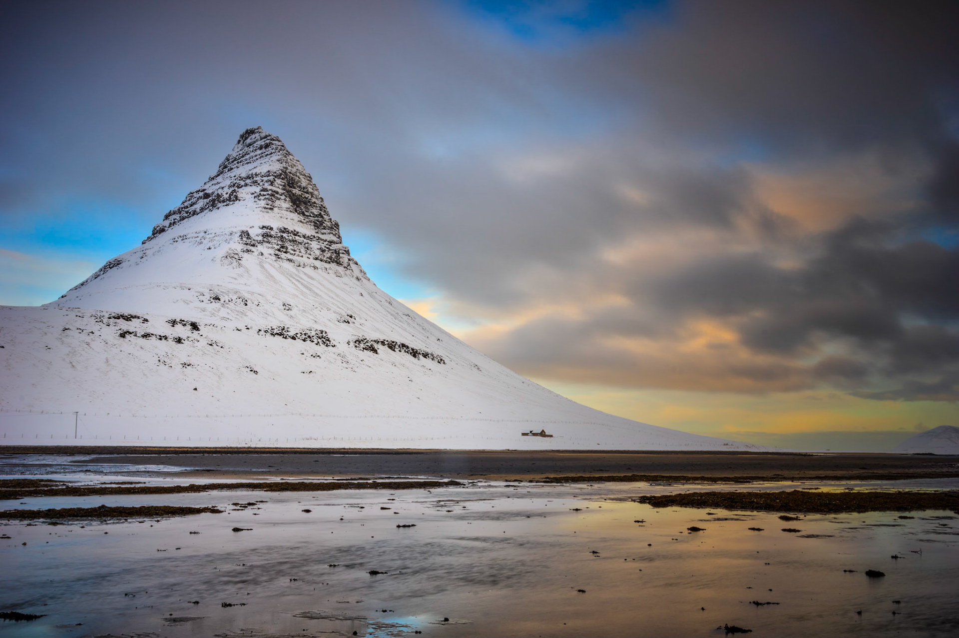 Kirkjufell, on the Snæfells Peninsula, near the village of Grundarfjörður.Vesturland, IcelandFebruary 6, 2016This is an HDR image merged in Photomatix Pro, with additional processing in Lightroom and Photoshop.PENTAX K-3, Sigma 18-35mm f/1.8 DC HSM ArtISO 100 22 mm  0.3 sec at ƒ / 16