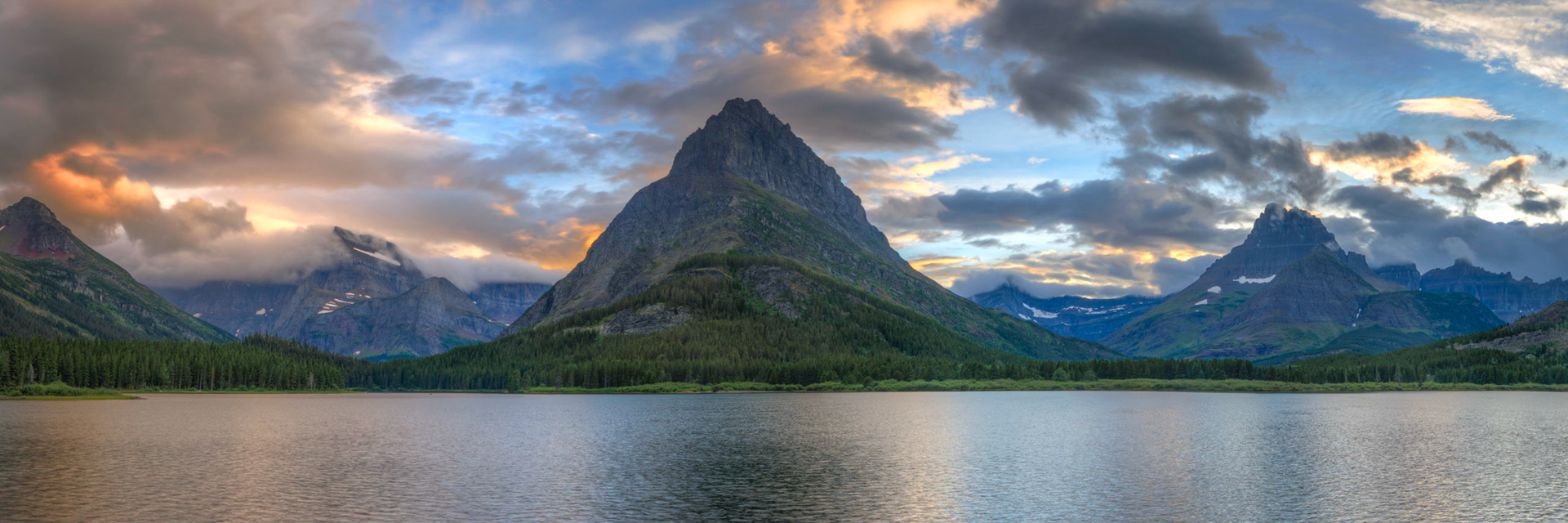 Sunset at Swiftcurrent Lake, right outside of the Many Glacier Hotel.Glacier National ParkJuly 27, 2015This is an HDR panoramic image consisting of 7 frames comprised of 5 exposures each. HDR processing performed in Photomatix Pro.  Panoramic stitching performed in Photoshop. Additional processing performed in Lightroom and Photoshop.PENTAX K-3, Sigma 10-20mm f/4-5.6 EX DCISO 100 20 mm  ⅛ sec at ƒ / 11
