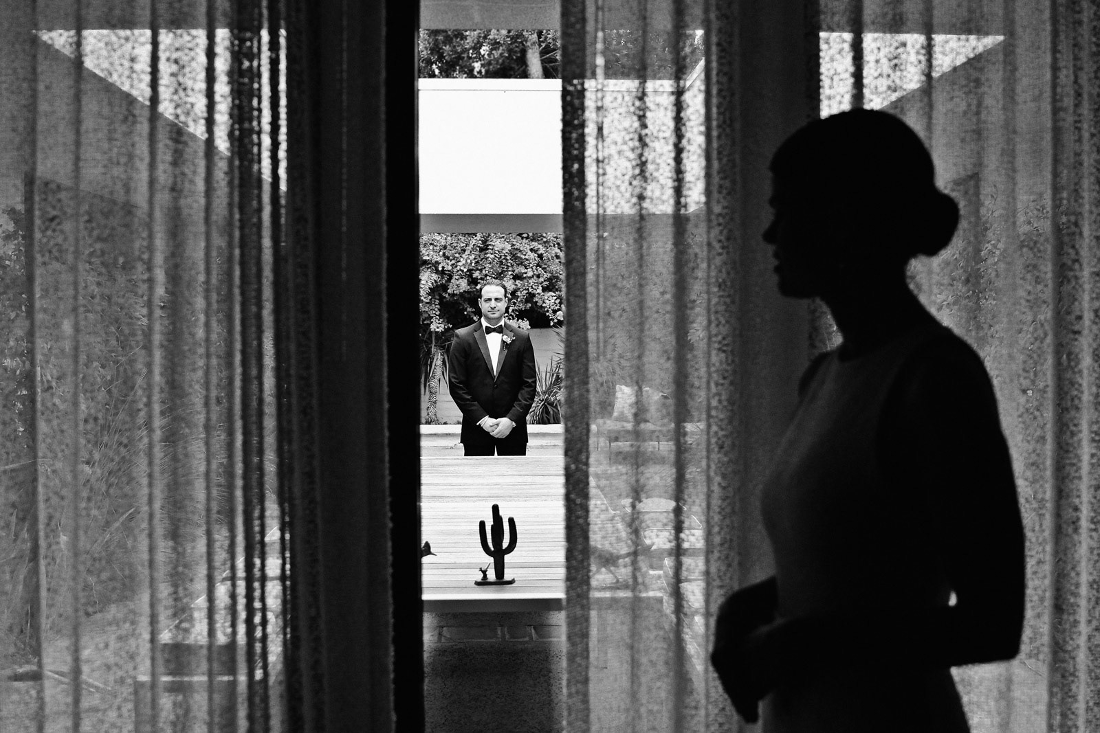 First look, groom waits outside to see bride before wedding
