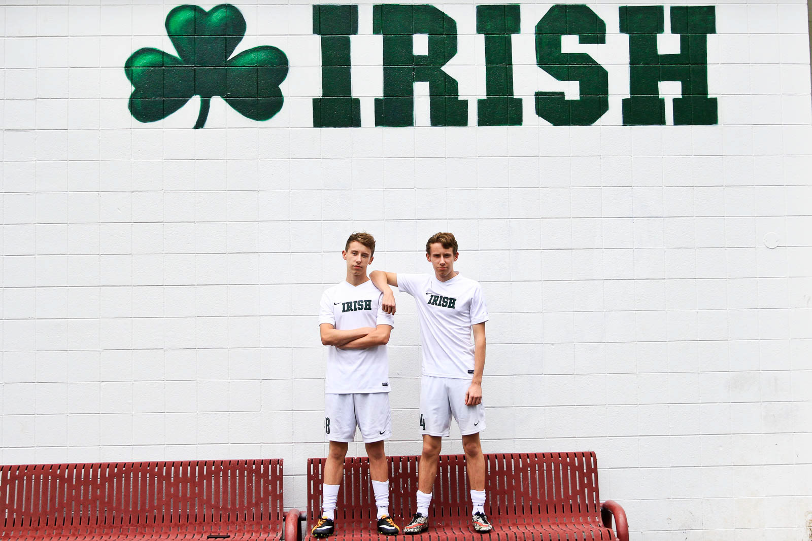 High school seniors stand in front of their school
