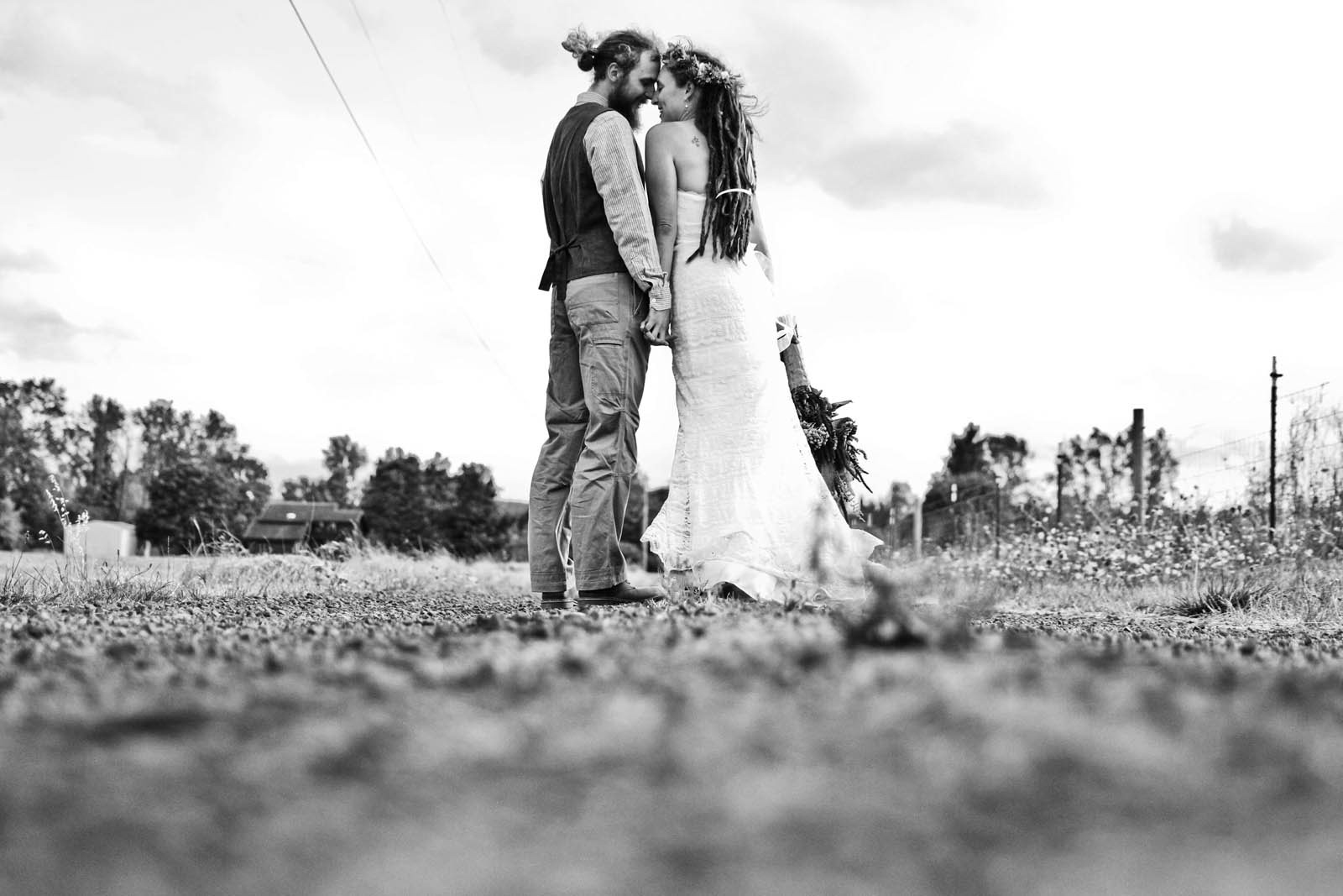 Couple in love on a dirt road near rural outdoor wedding in Oregon