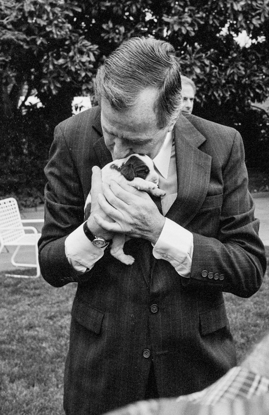 President George H.W. Bush with one of the new litter of puppies from Millie, February 28, 1989.