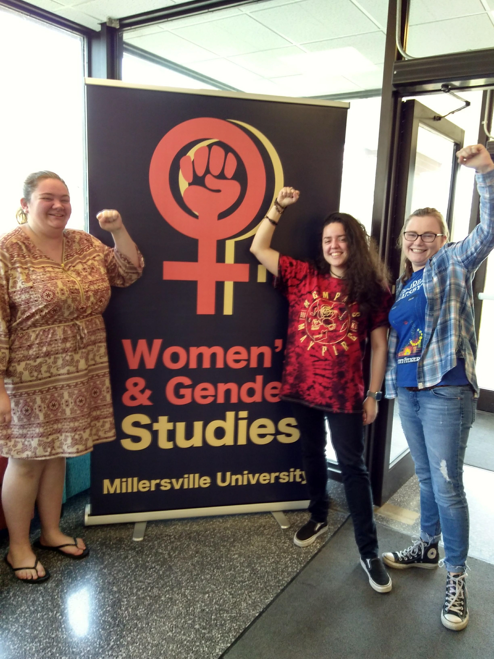 Members of the Women's and Gender Studies Minor standing with the promotional banner