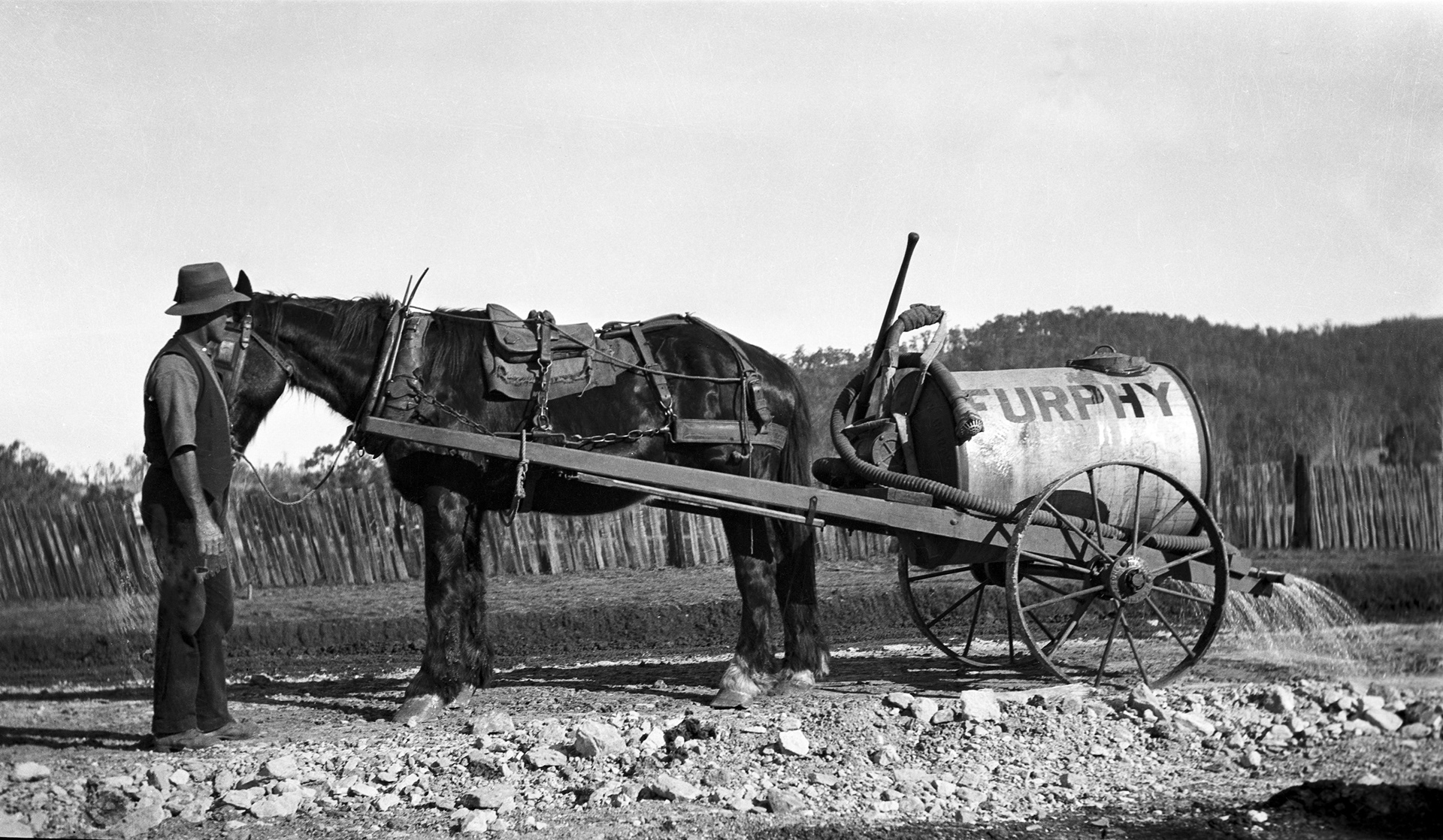 Historic horse drawn vehicle used to spread water across dirt roads