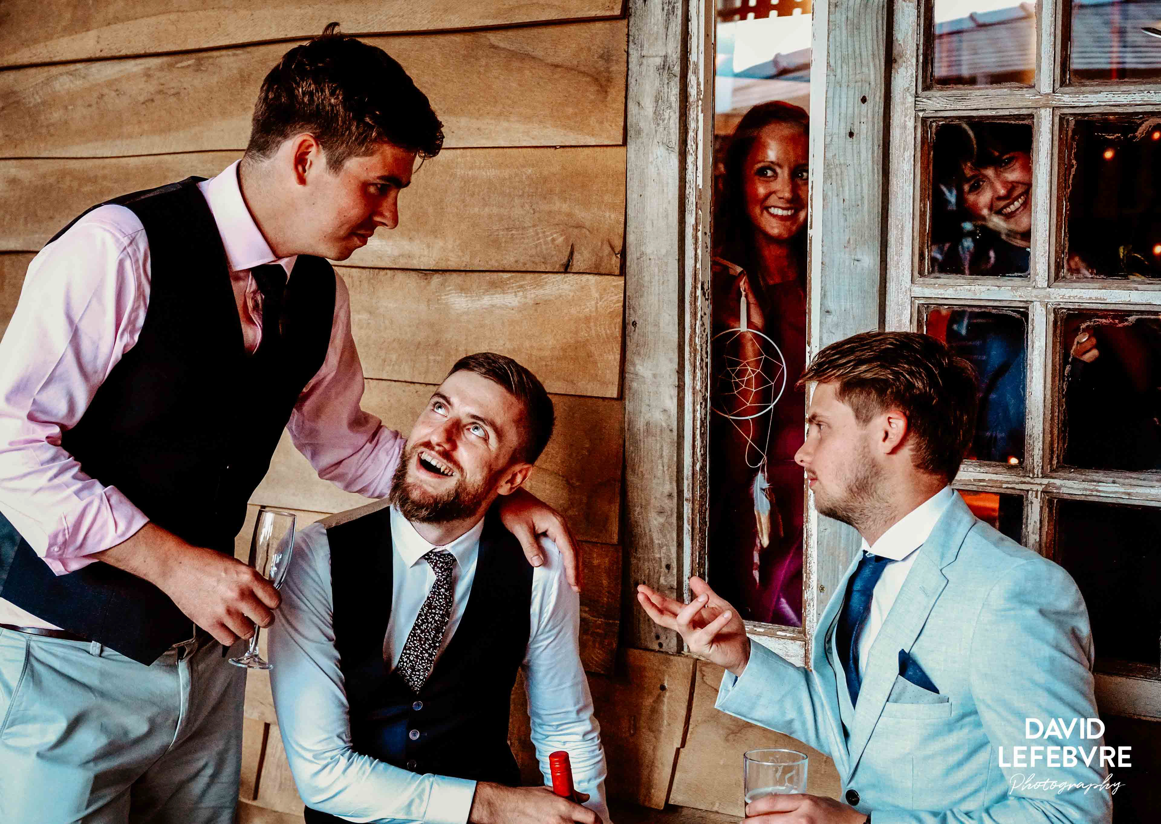 guys discussing girls whilst the girls spy on them at owen barn wedding