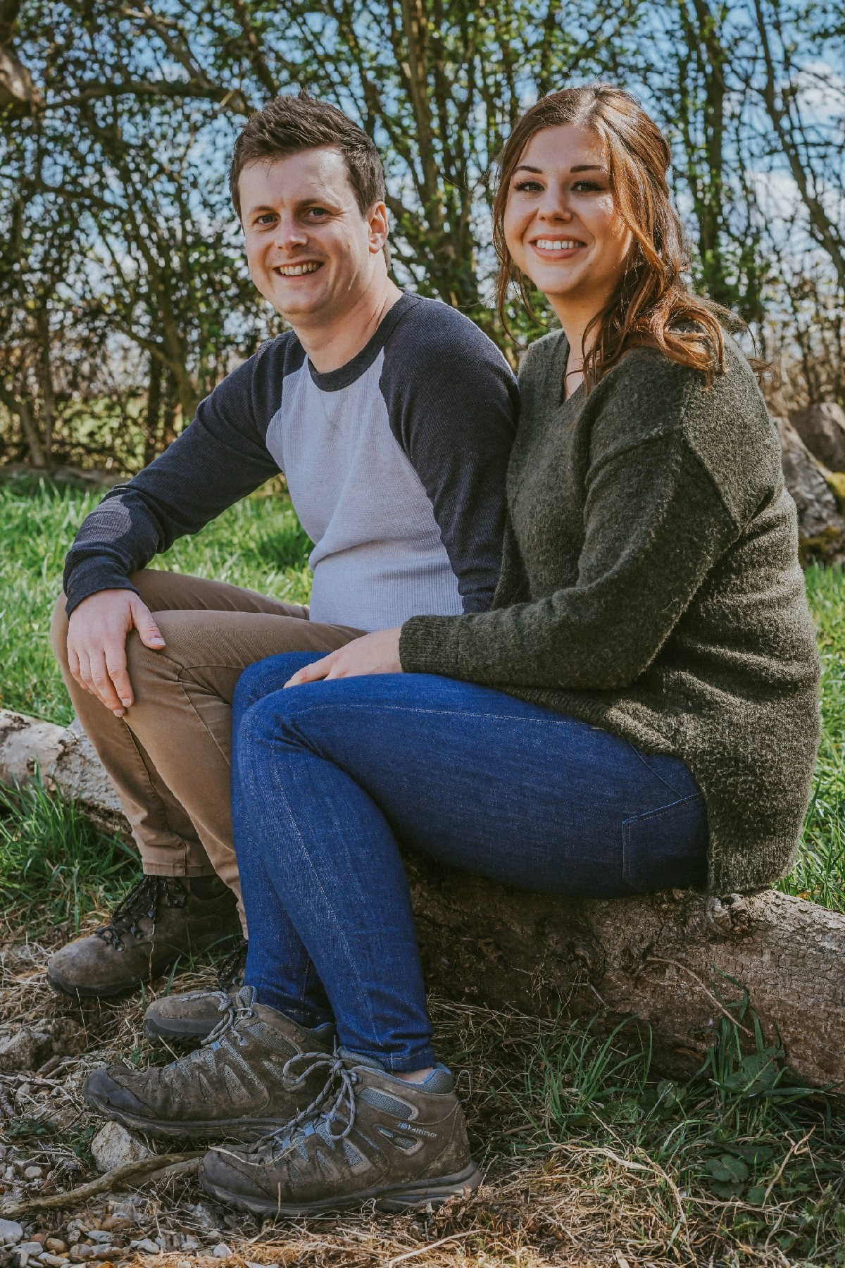 young couple smiling whist having a pre wedding engagement shoot with david lefebvre down at the endeavour woodland wedding venue in swanbourne near winslow in buckinghamshire its a beautiful sunny day