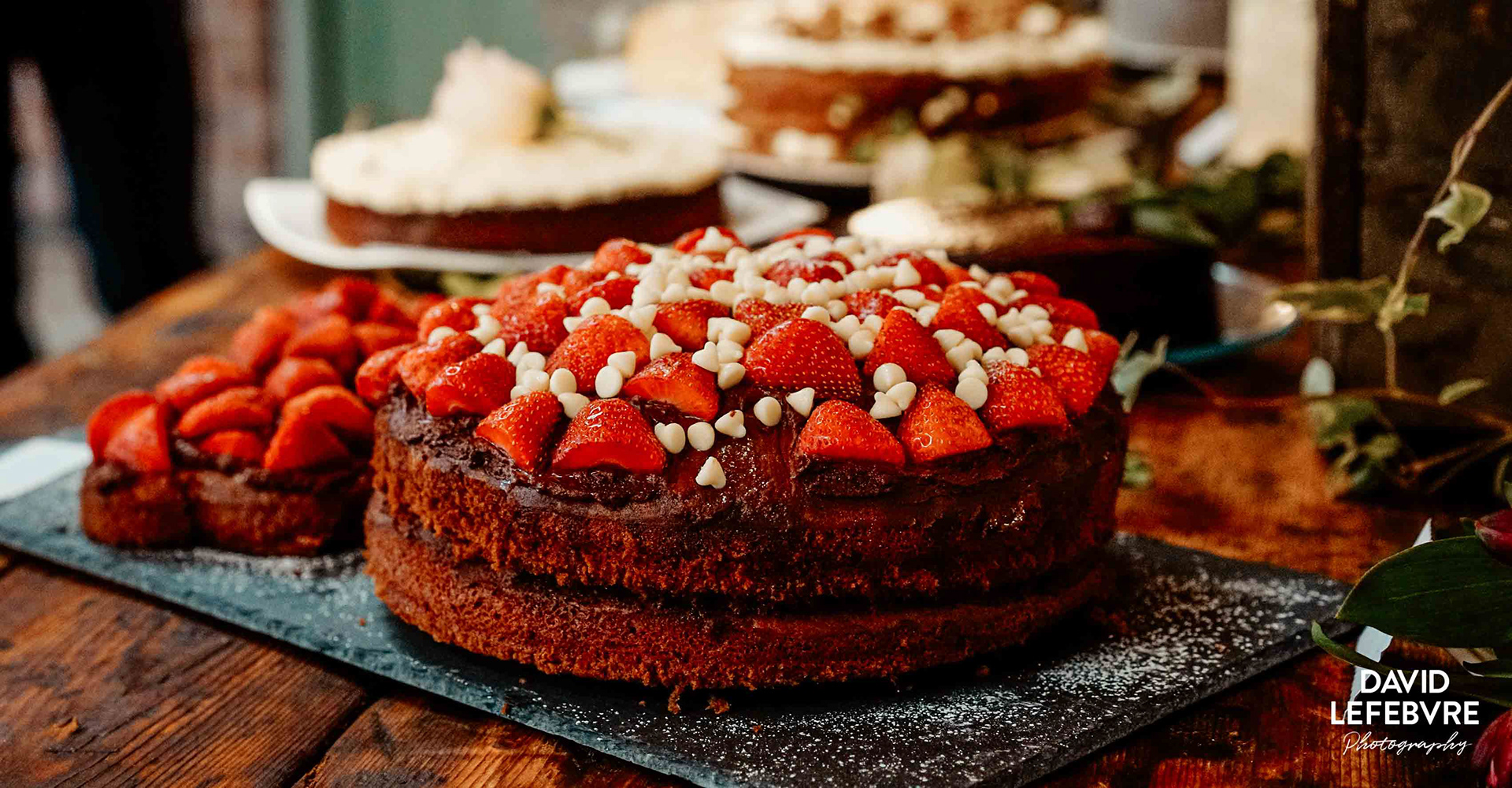 stunning dark chocolate cake with strawberries and white chocolate at owen barn house wedding
