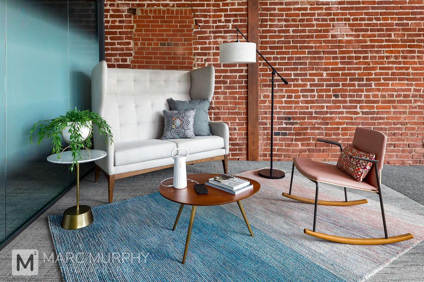 Workspace Interiors Lounge Waiting Area with Steelcase, brick wall, couch, chair, coffee table and lamp
