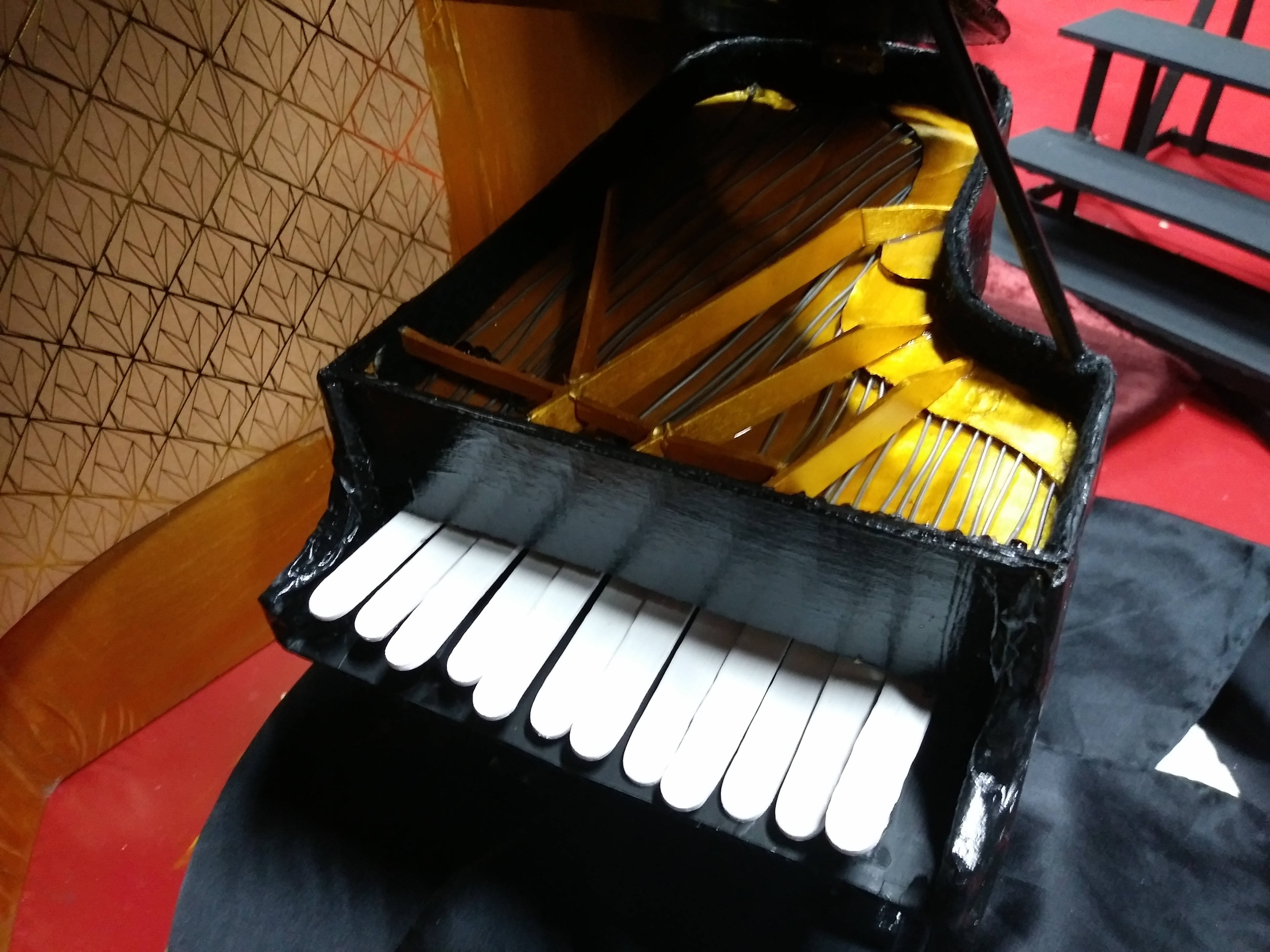The grand piano made from cardboard, popsicle sticks, iron thread