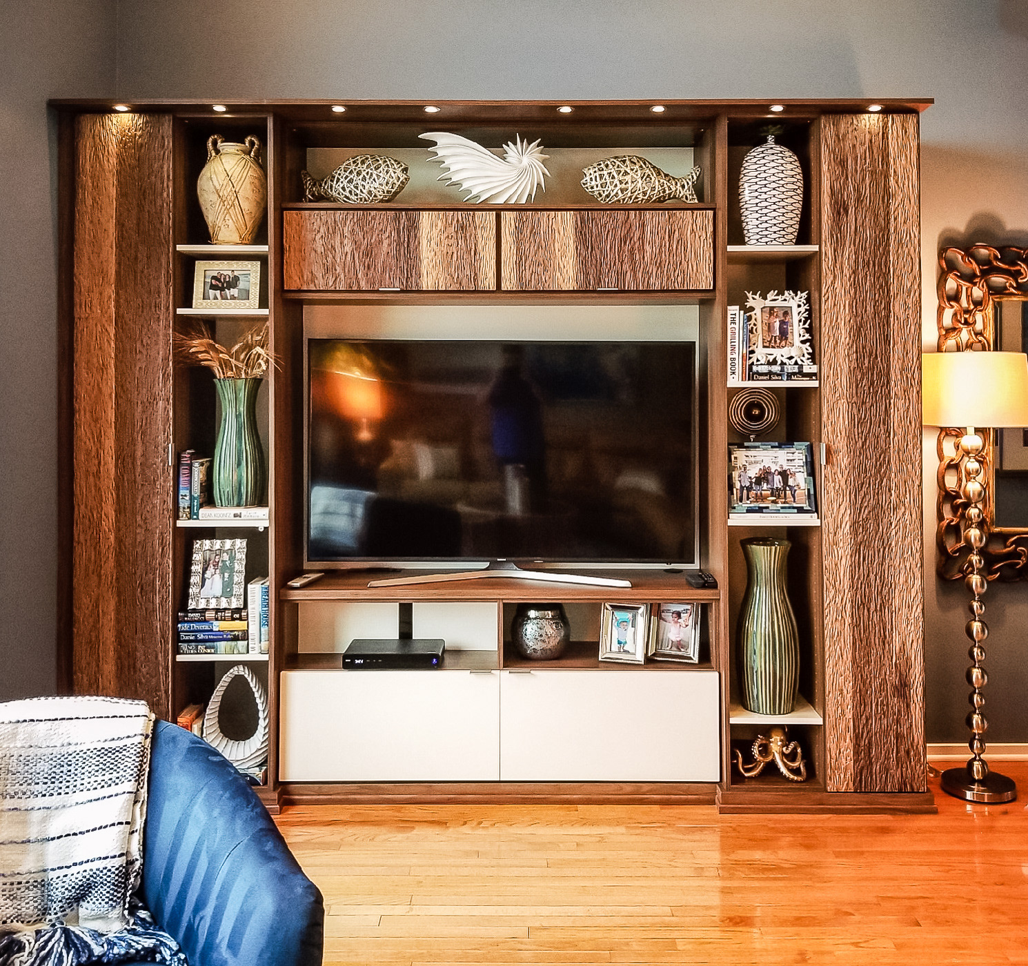 Custom entertainment center with textured walnut and lighting