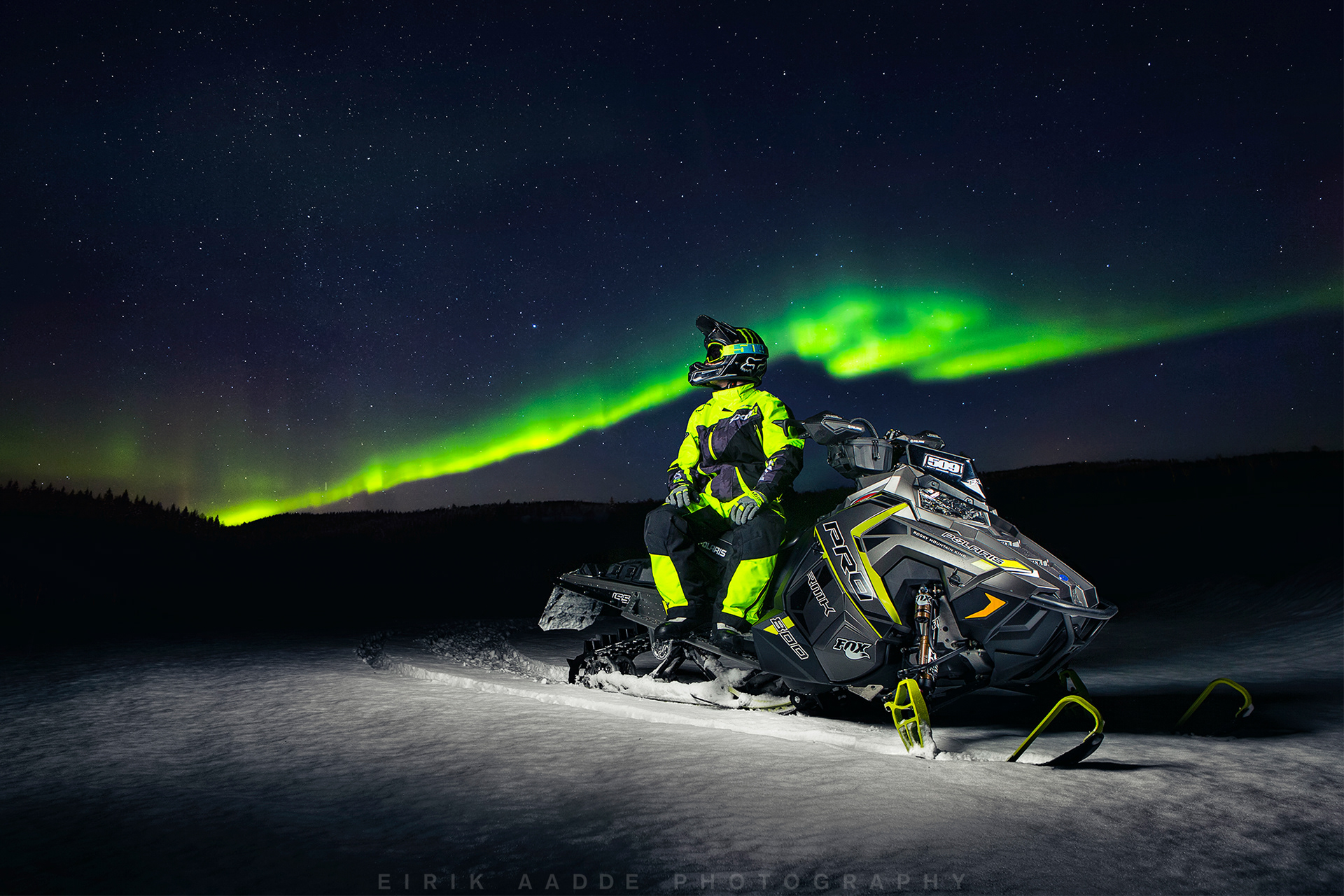 Riding Polaris snowmobiles under the northern lights Location: Bardufoss, N...
