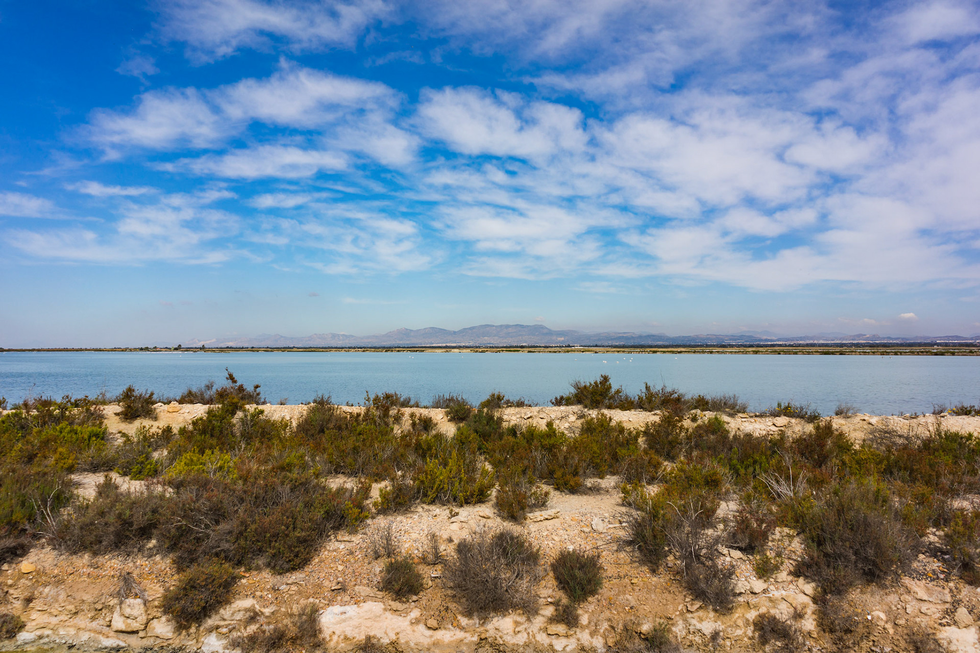 Blue sky with clouds over Lake and Mountains in Spain.