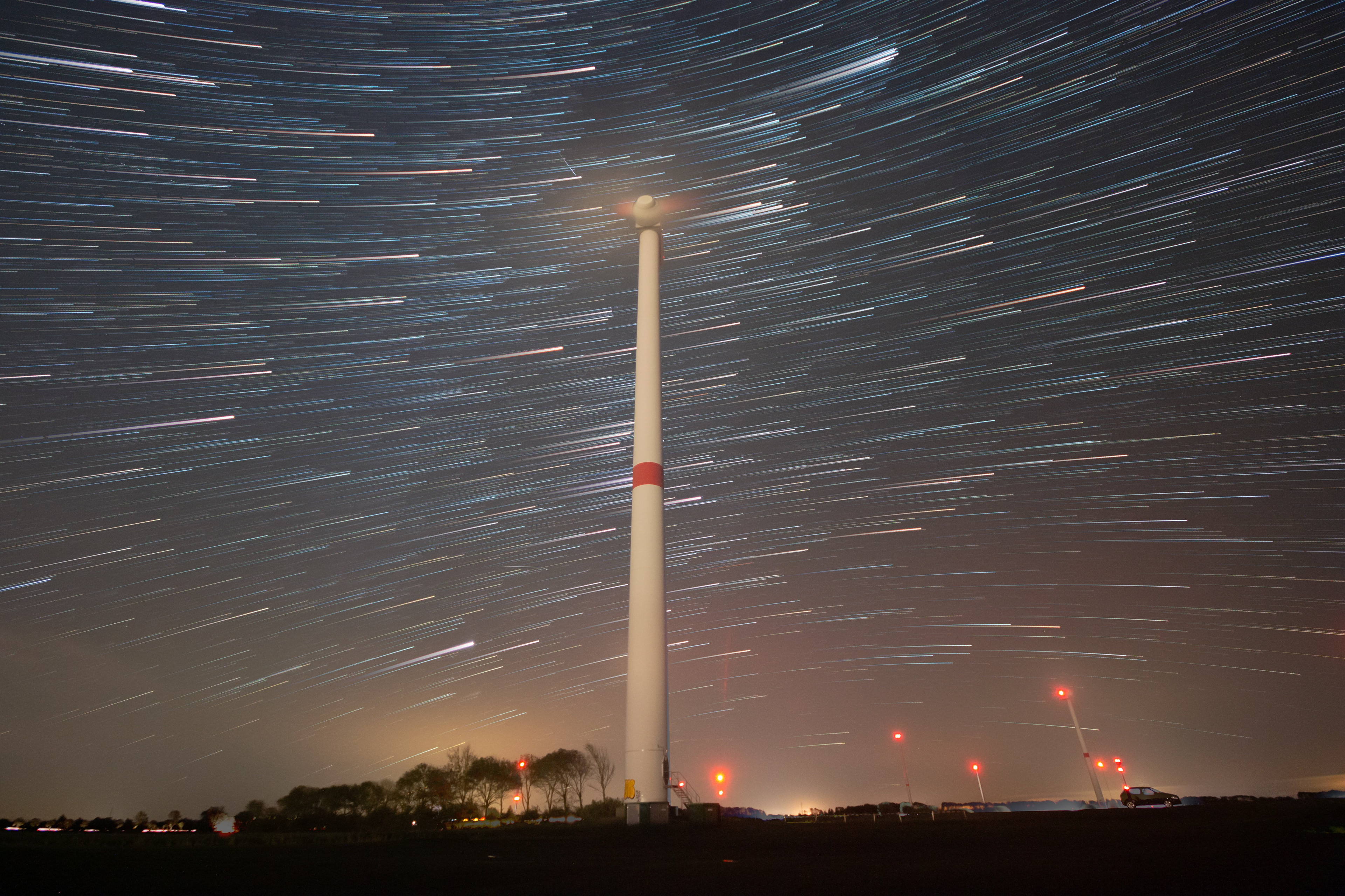 Startrail behind a wind turbine