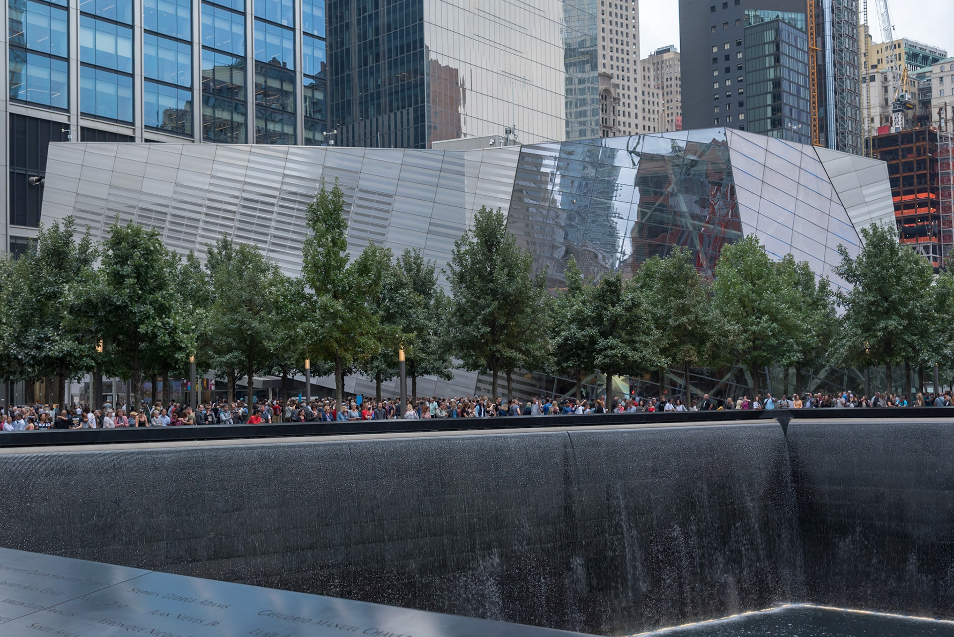 Entrance to the 9/11 Museum beyond one of the Memorial pools, Manhattan