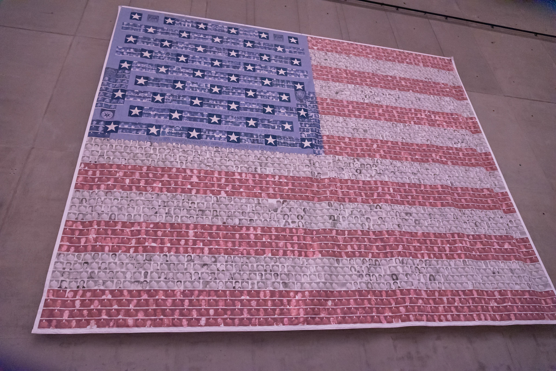 Individually produced and hand-sen squares representing each victim of the 9/11 attack, Manhattan. Where a photo wasn't available, there's a candle. Stars & blue section represent the first responders who died