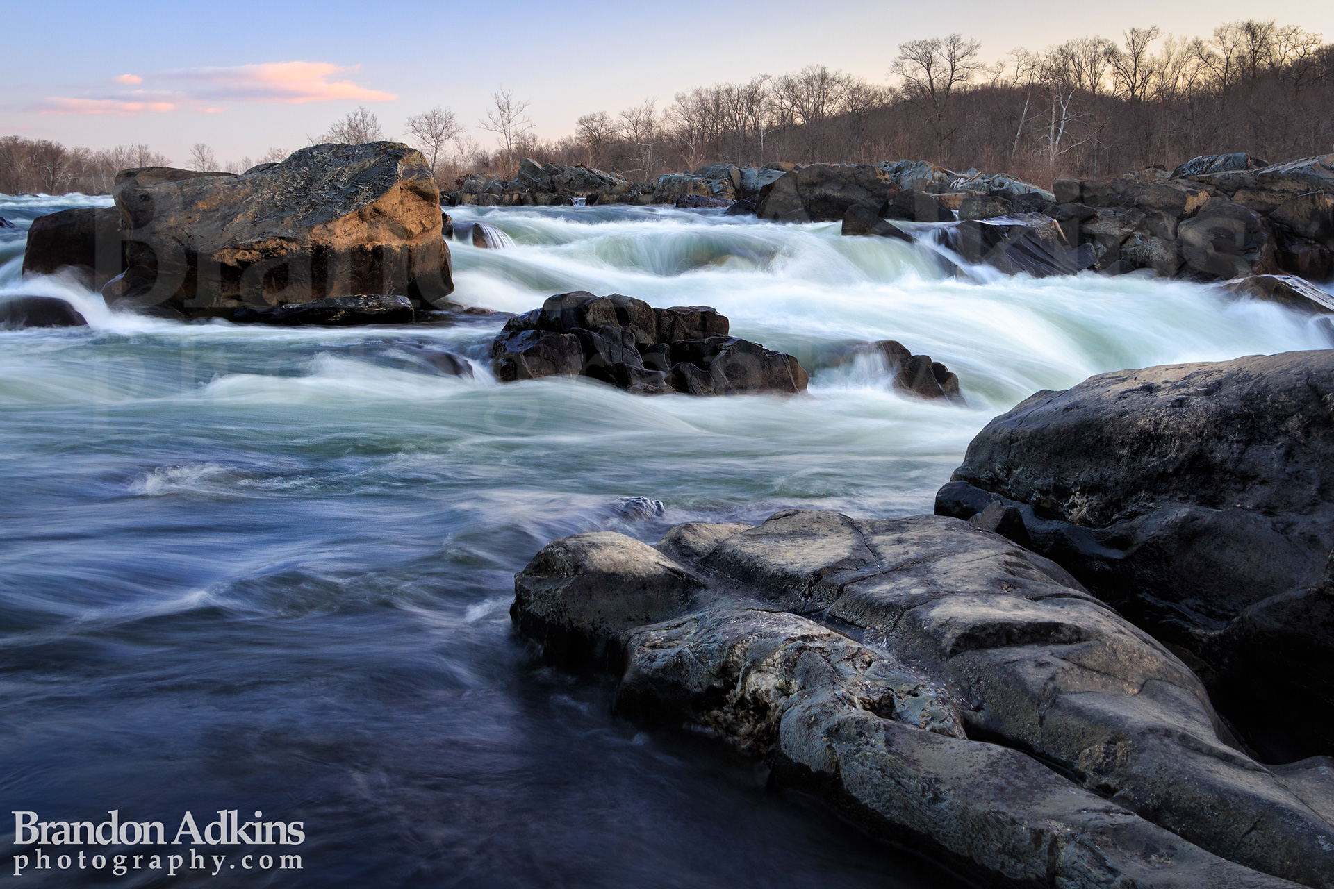 Fine art photograph of Great Falls Park in winter with rapids rushing around boulders