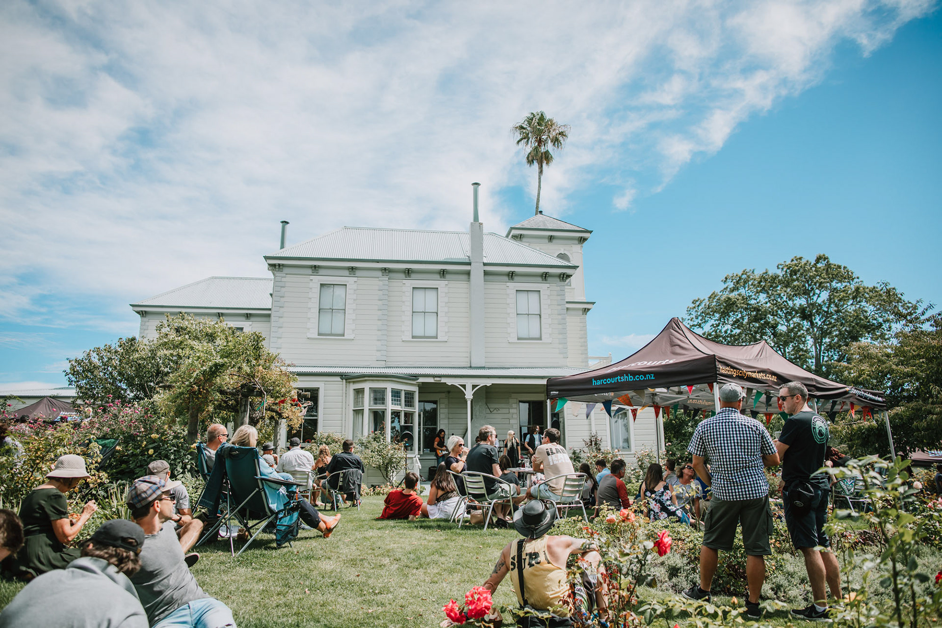 Havelock North's Duart House garden with festival goers sitting in the sun
