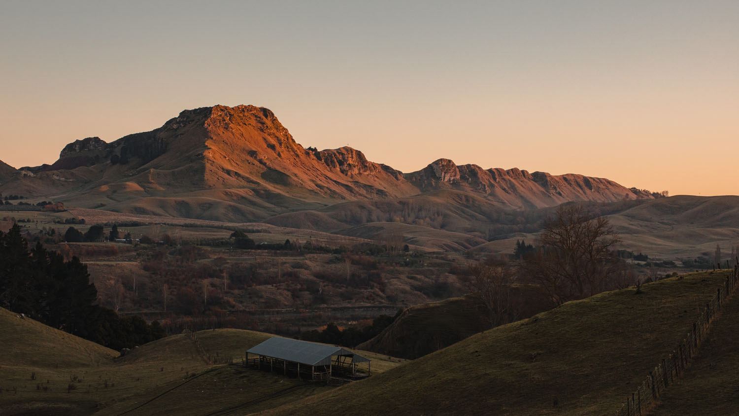 Looking across Tuki Tuki valley farmland with the early sunlight hitting Te Mata Peak