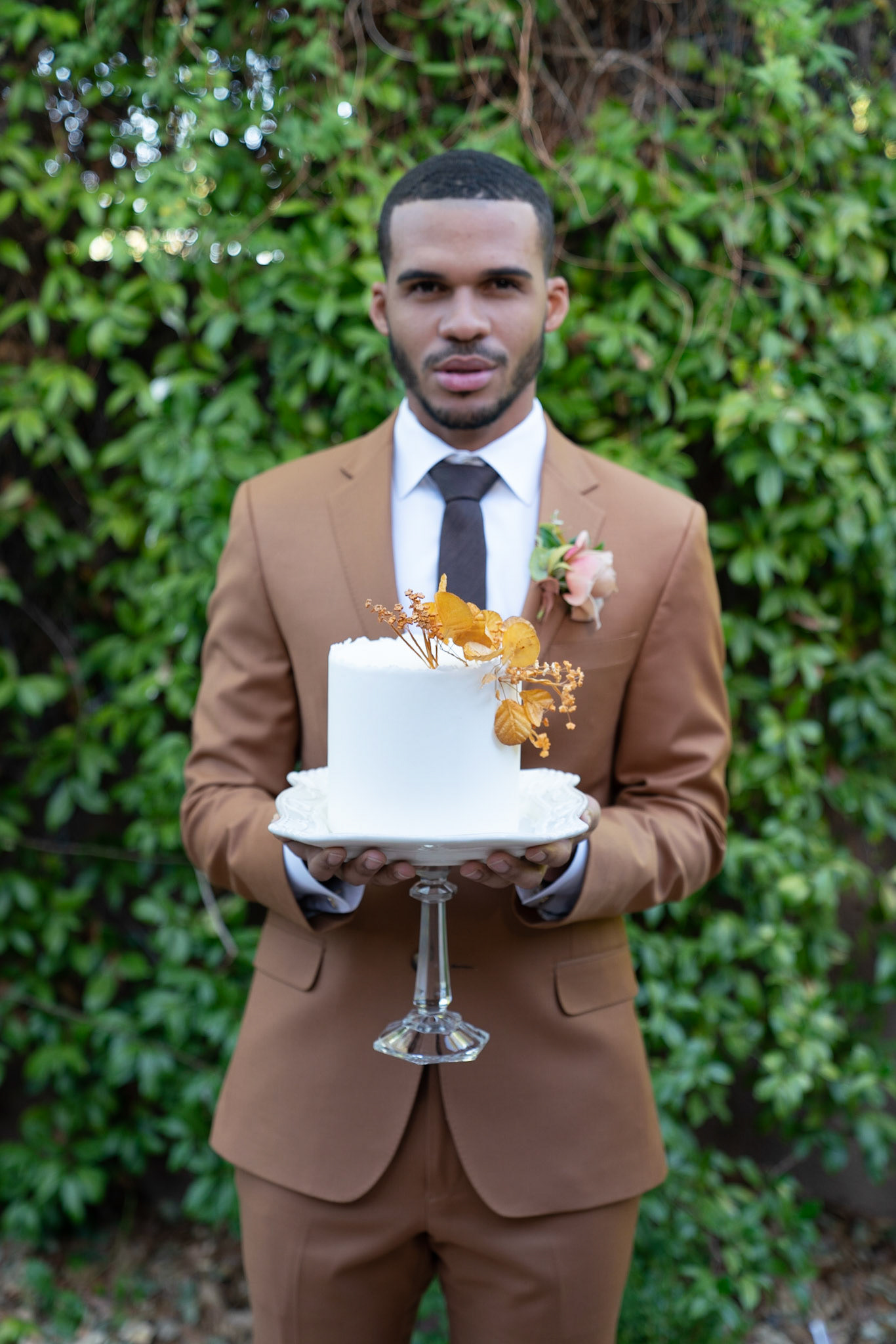 Groom holding top of cake to take home