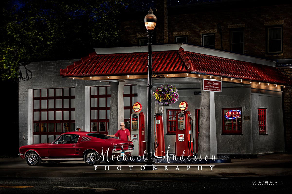 A beautiful light painted photo of the owner and his 1967 Ford Mustang in front of his Vintage Restored Gas Station in Carver, MN.